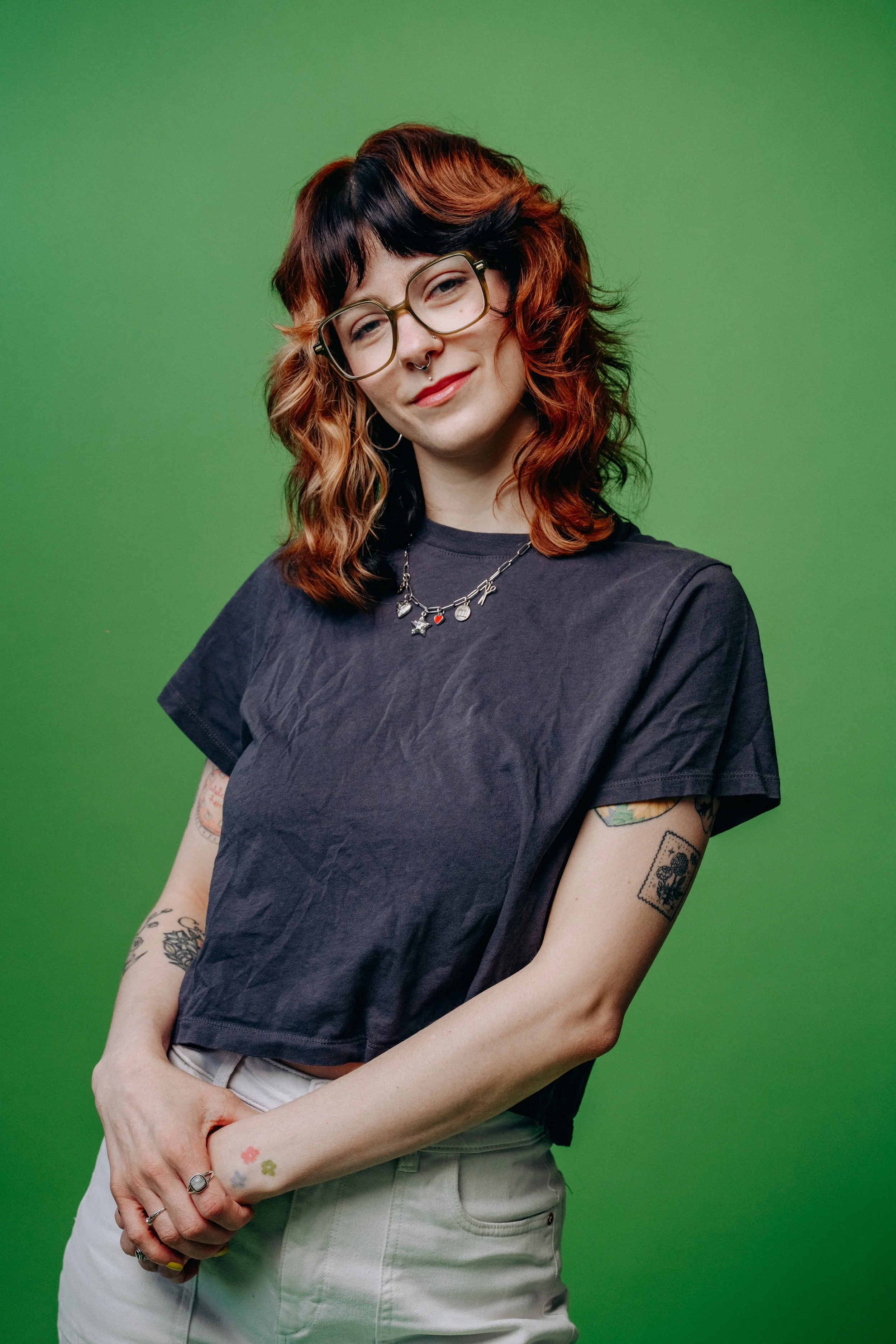 Syd (they/them) stands in quirky confidence with a calico shag haircut and calm confidence. You can tell that they are are expert Seattle hairstylist and are absolutely killing the game. That's why they create alternative hair seattle loves!