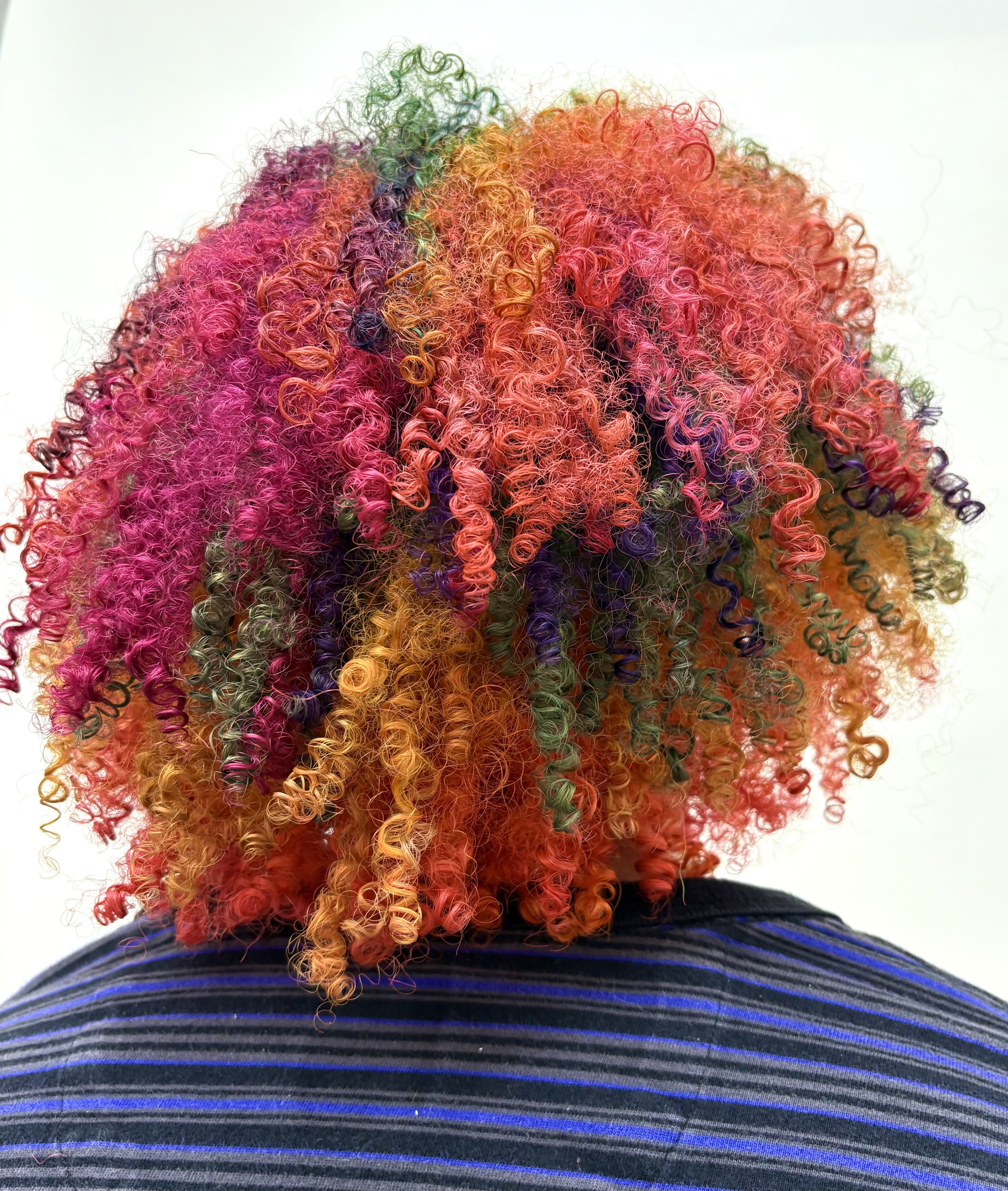 Lily is a Seattle hair colorist at Lady Neptune hair salon. She specializes in vivid color blocking as represented by this photo of color blocking on super curly hair.