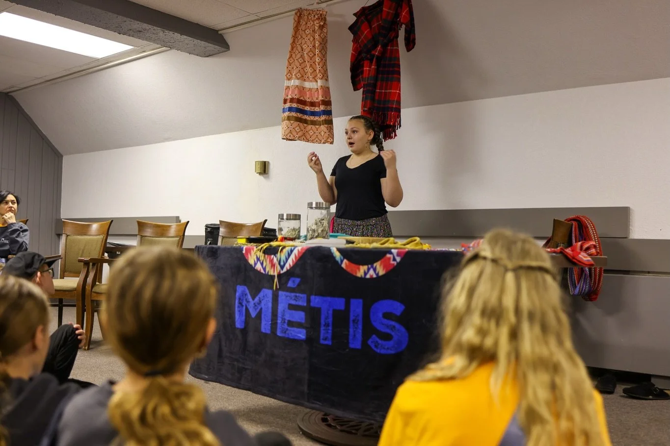 Tour Blog - DAY FOUR:
After checking out of our rooms and loading up the bus, we had a truly special presentation waiting for our choristers in the hotel rec room: A lesson by M&eacute;tis cultural educators Aleigha Aaker, April Aaker, and special gu