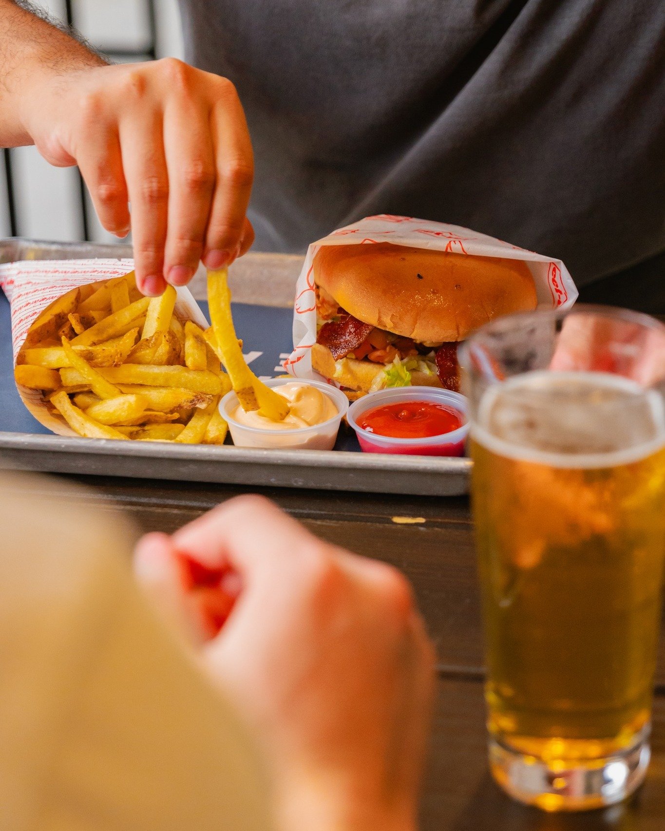Today, we're excited to highlight our friendly neighbor, @eet_up, centrally located within @makereadymkt. 🍔 Their mouthwatering hamburgers and crisp fries pair perfectly with our diverse selection of draft beers. Psst, don't miss out on their must-t