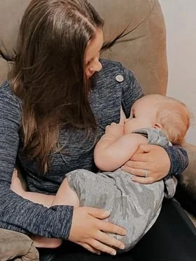 Picture of a mother feeding her newborn baby.