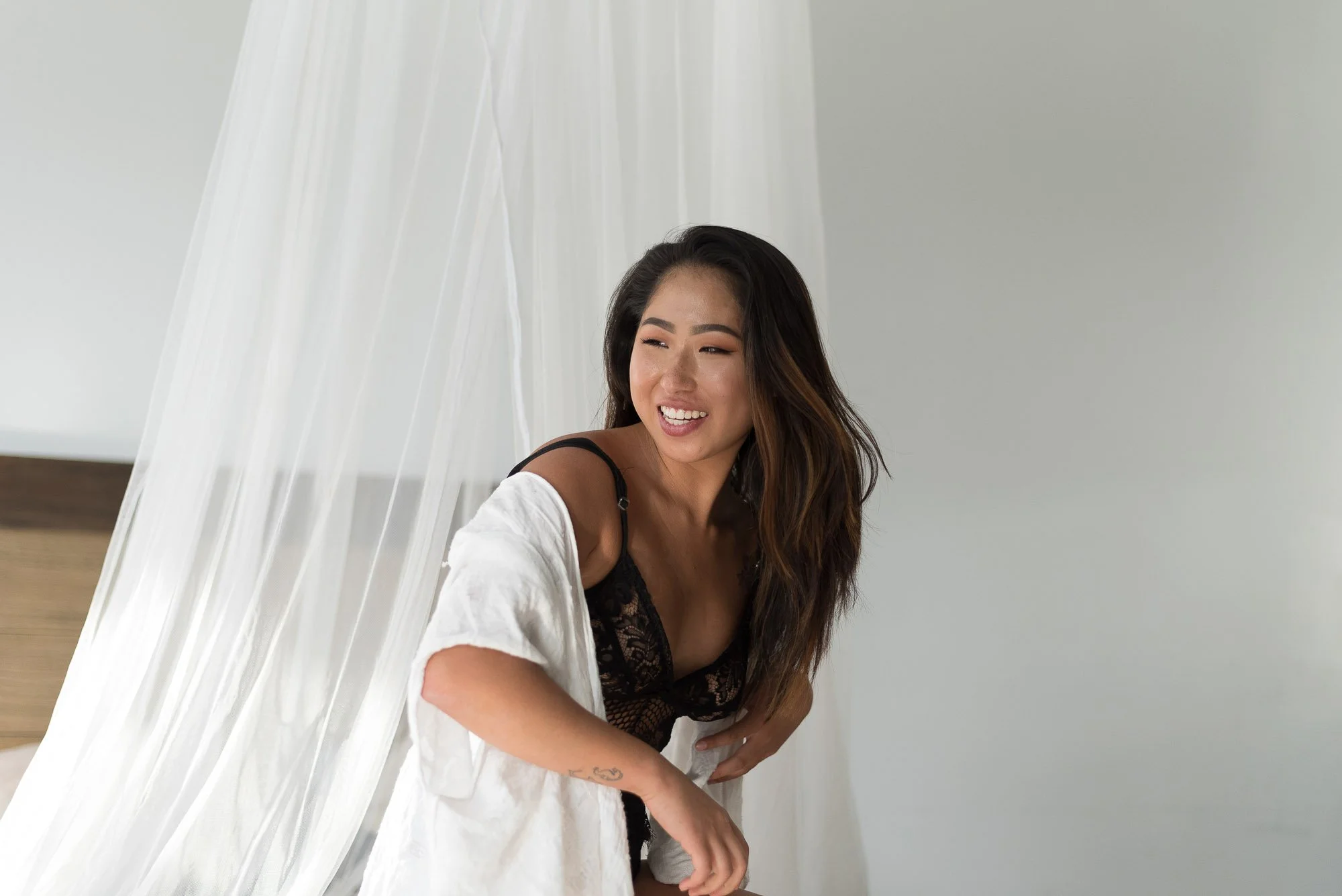 Woman laughing during a boudoir session at Black Kat Studios in Los Angeles.