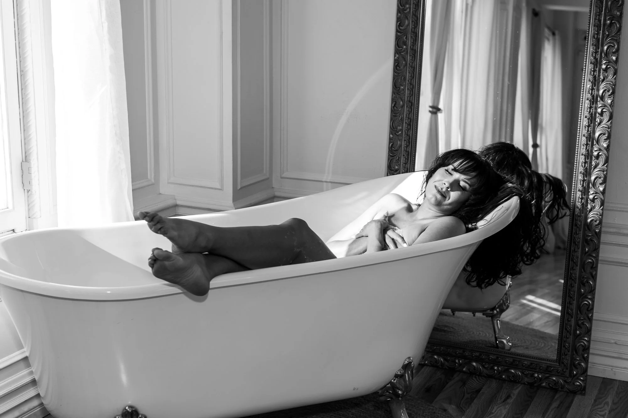 Woman relaxing in a bathtub during a boudoir session at Black Kat Studios in Los Angeles.