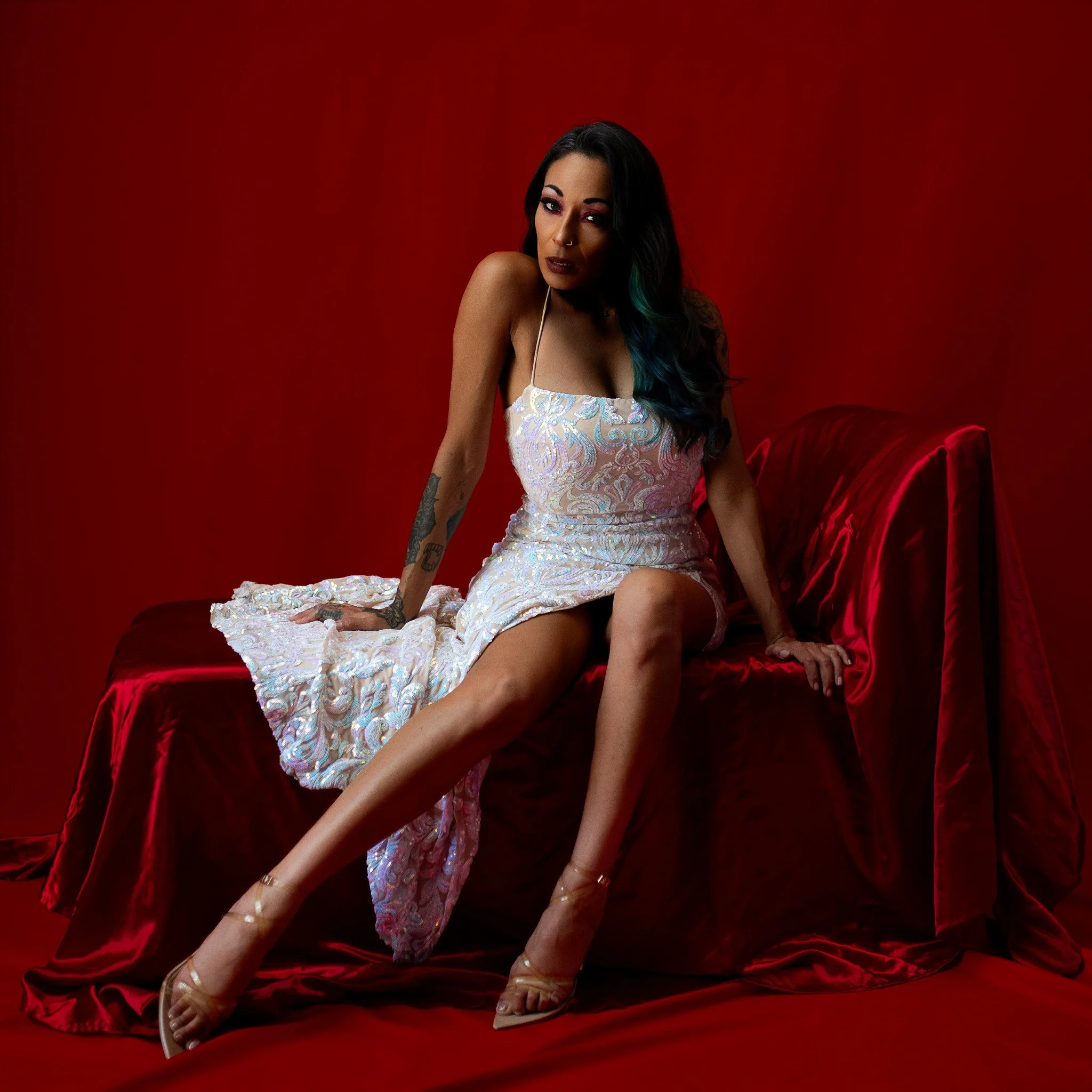 Glamour photography Los Angeles woman in white dress against red background Black Kat Studios