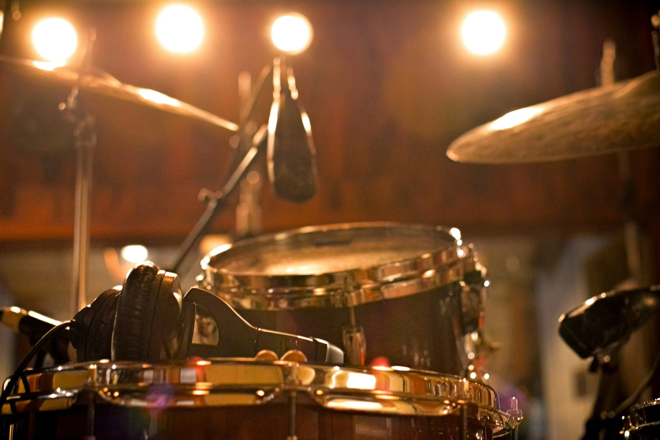 A set up of a drum kit with microphone to do a home recording during a lesson.