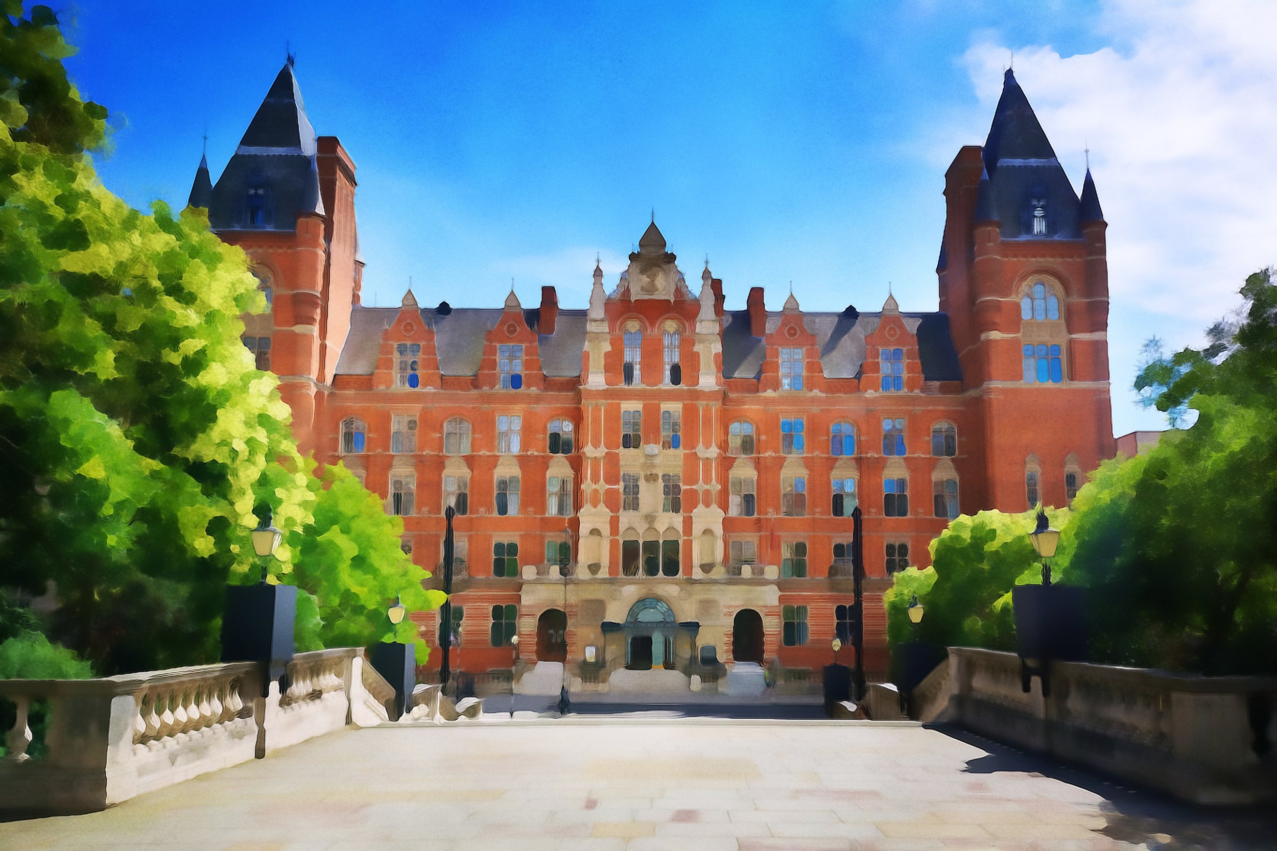 A historic building with red brick surrounded by green trees and blue skies.