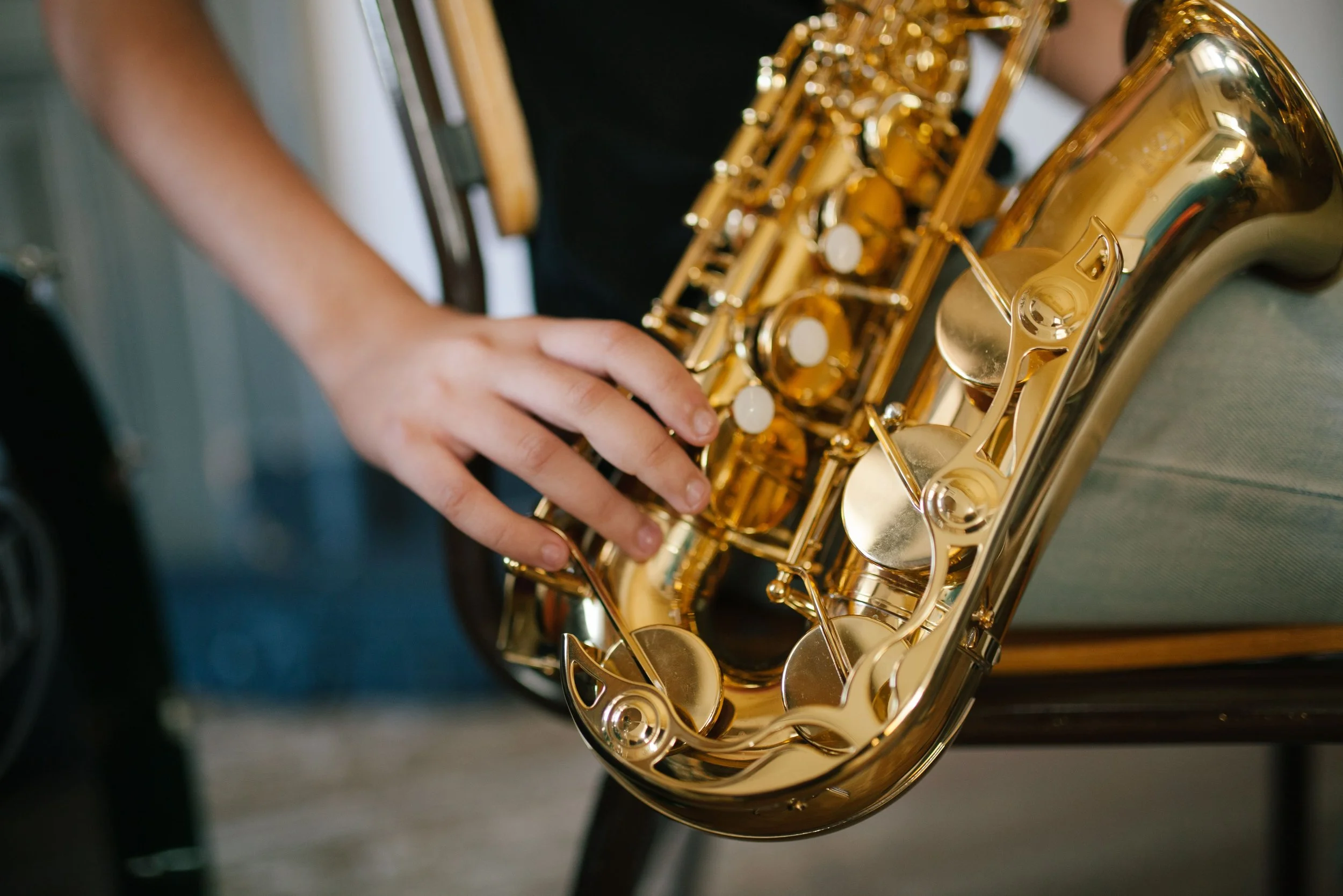 A close-up on hands playing the saxophone in London.