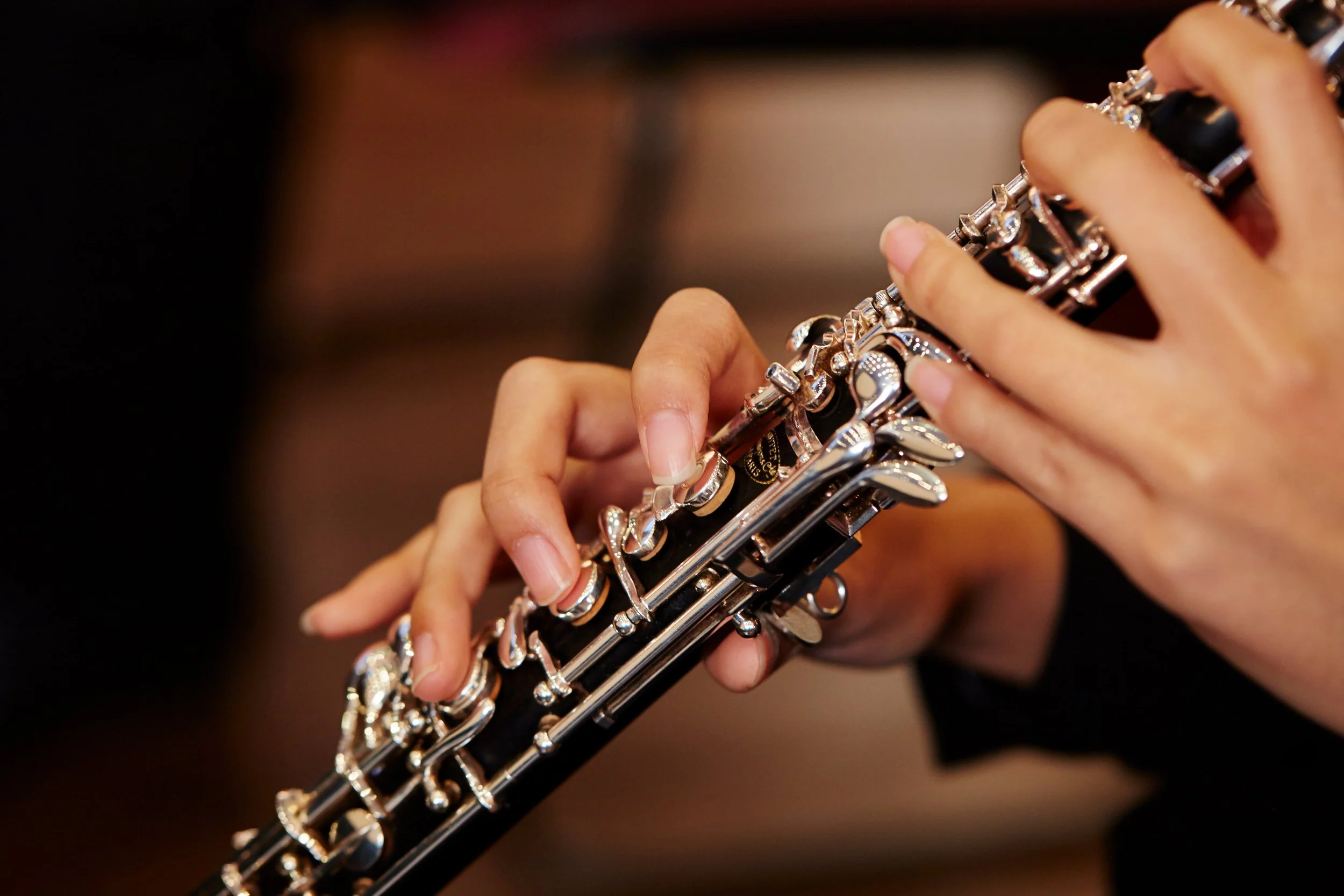 A close-up of hands playing the oboe in London.