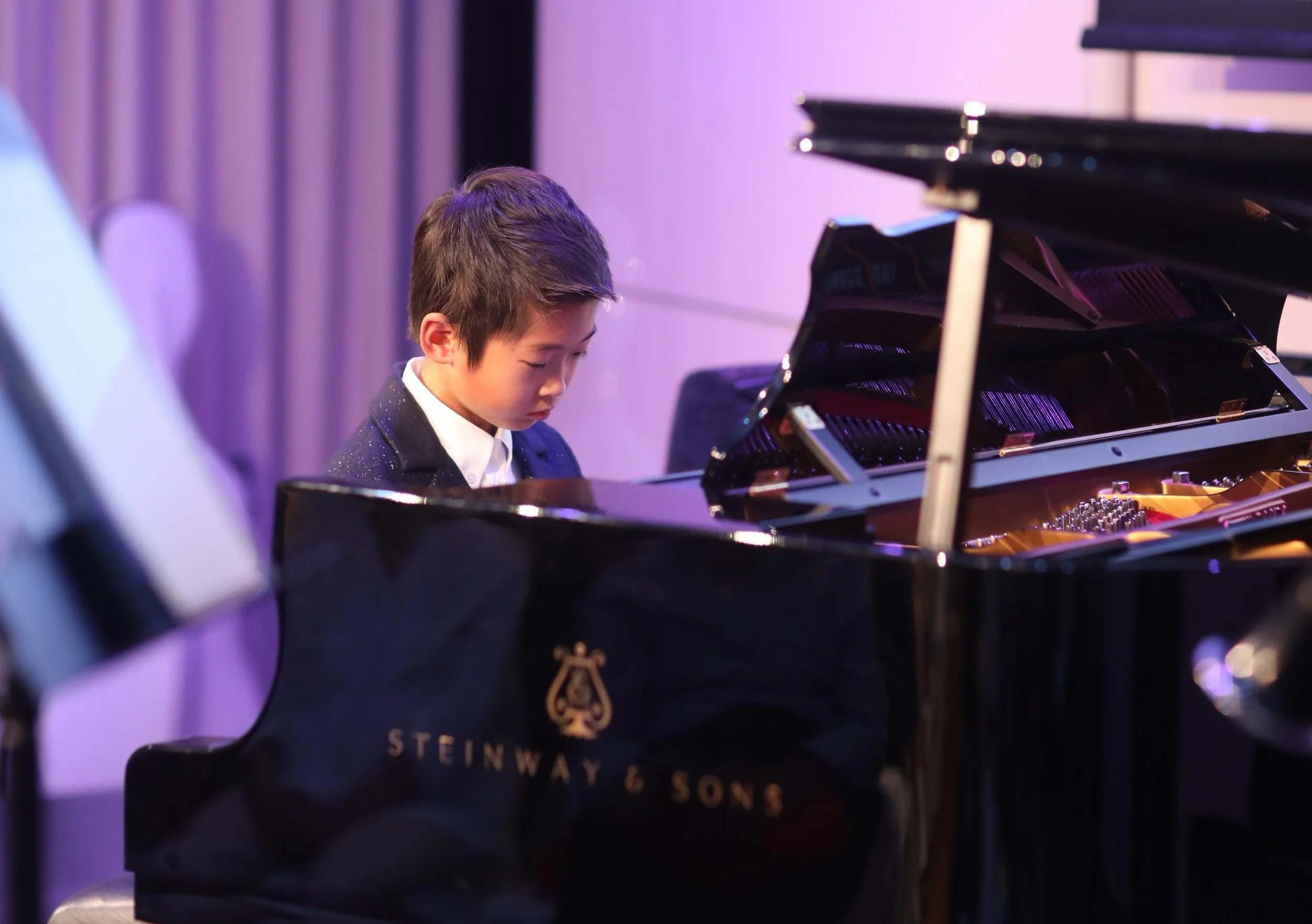 Piano performance at children's charity concert in London.