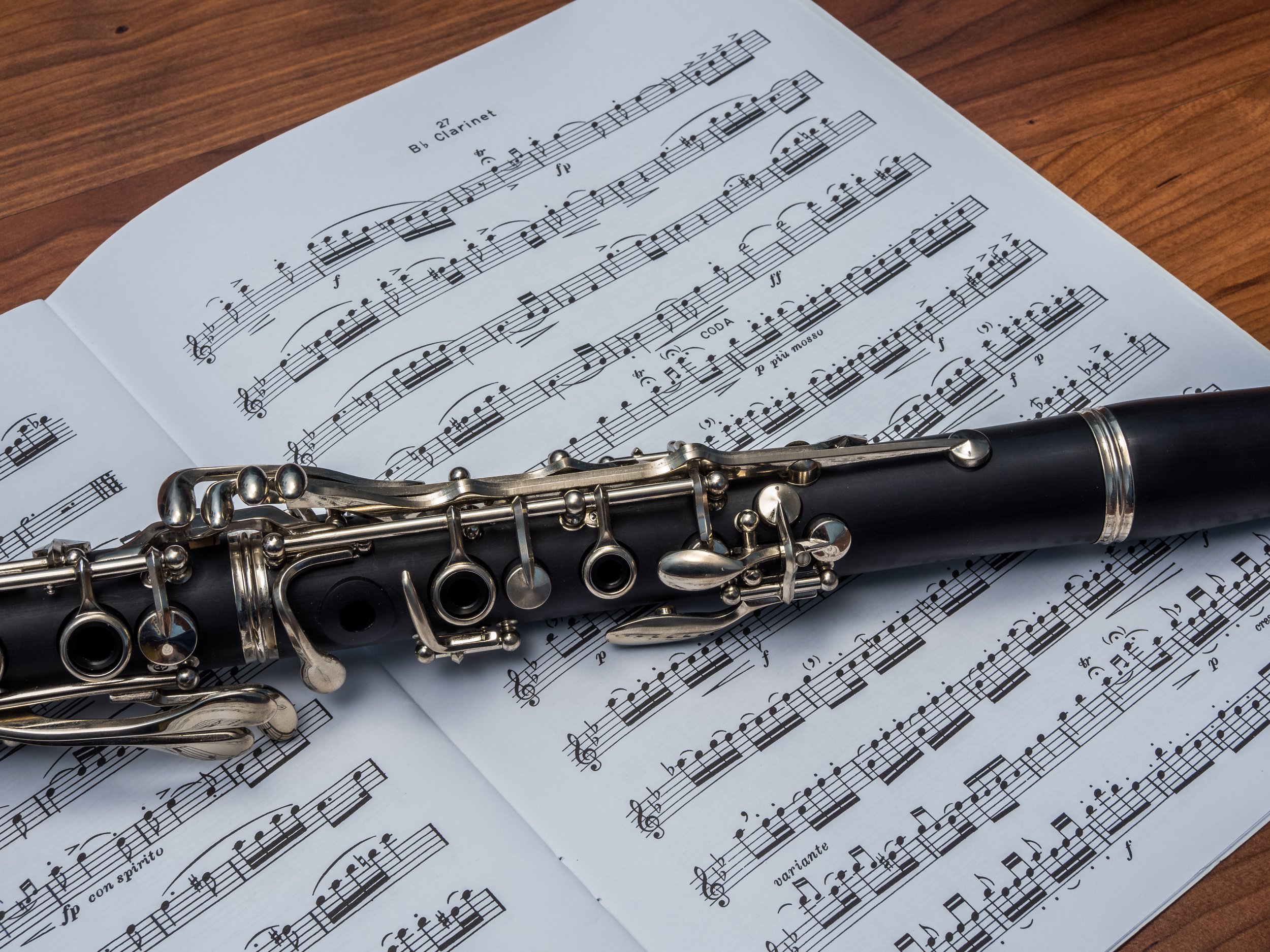 Close-up of a clarinet on top of sheet music.