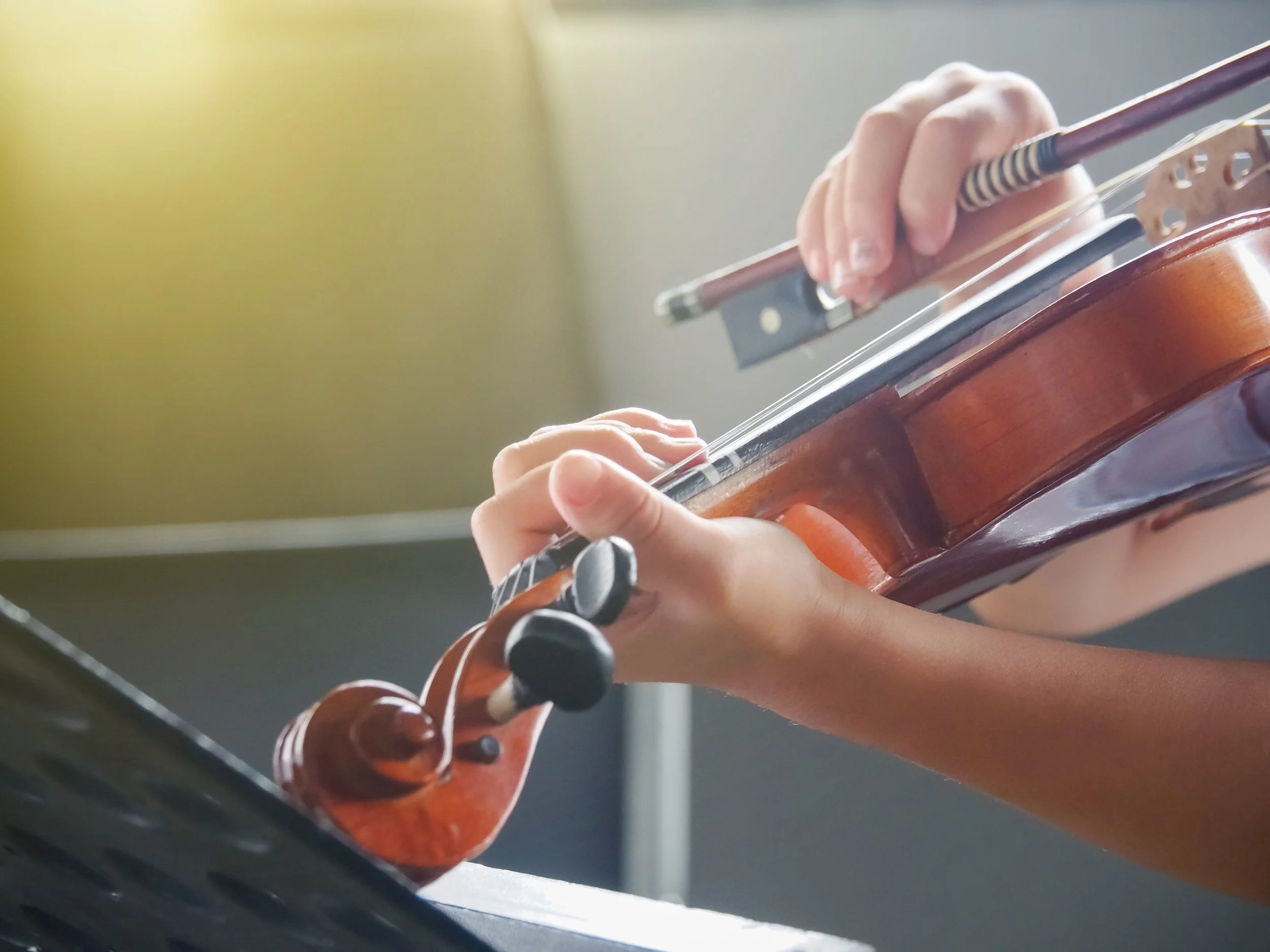A child practising the violin at home in London.