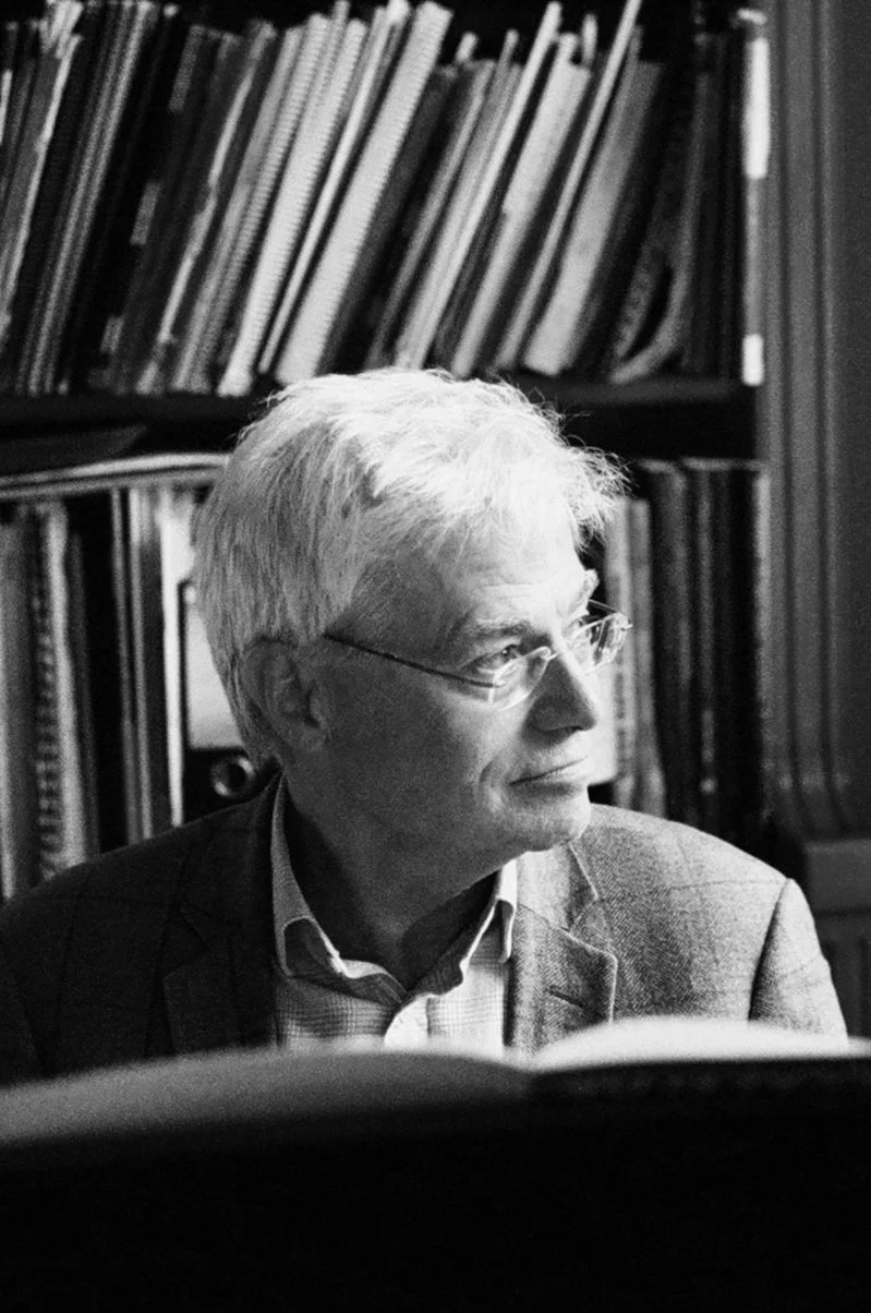 B&W photo of Ralph Alwood MBE in front of a bookshelf.