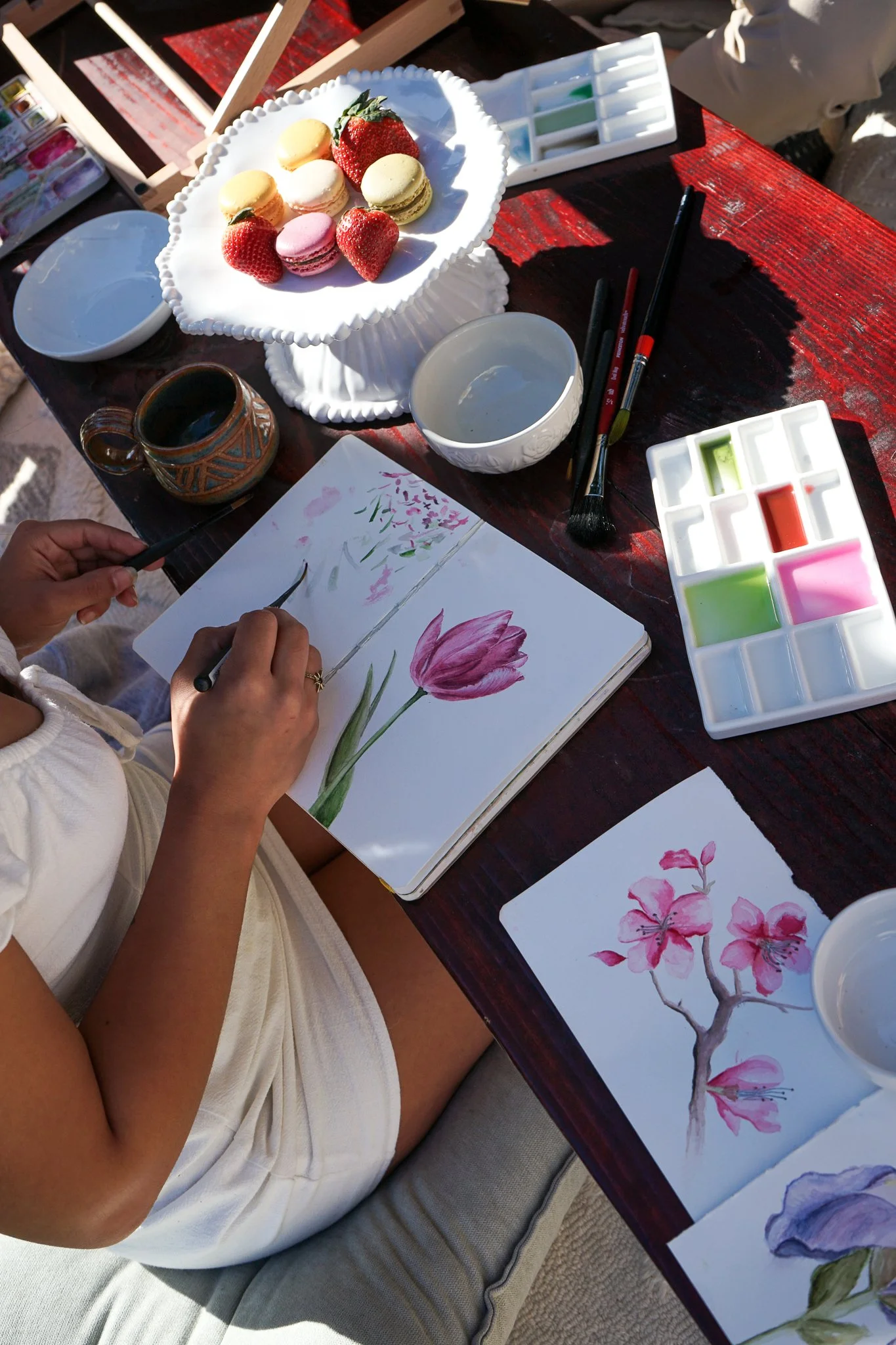 female painting watercolor tulip in san diego park