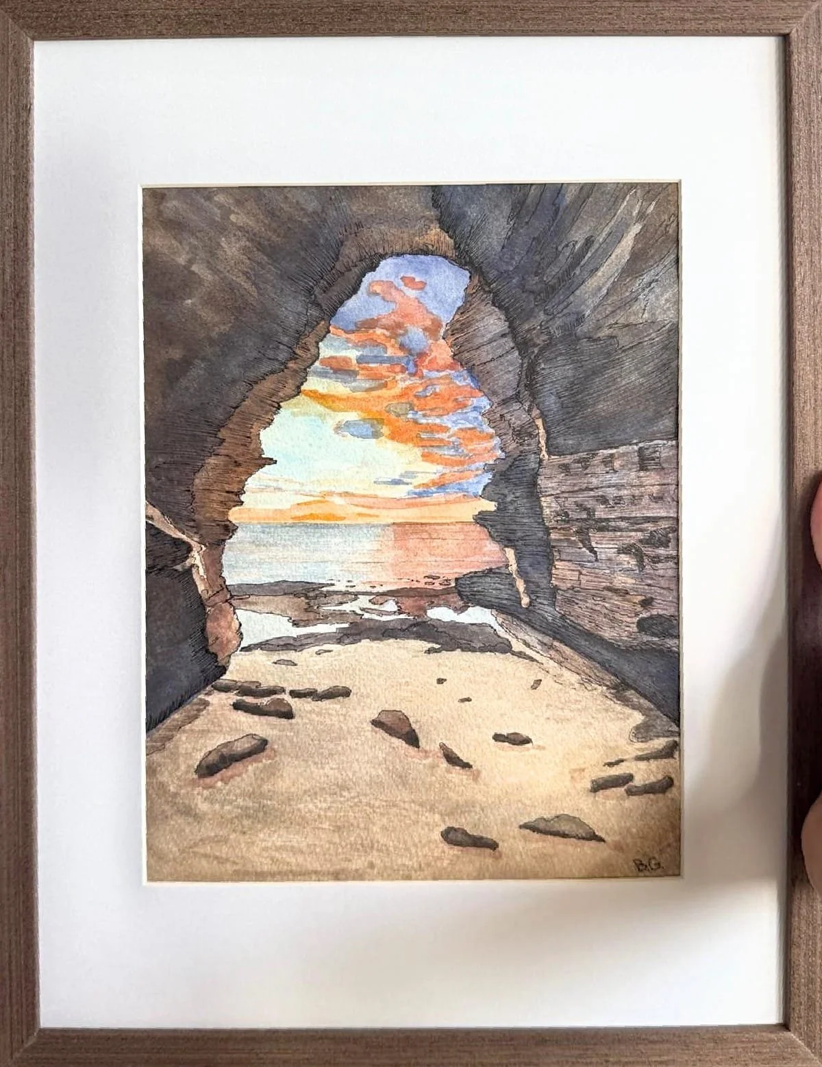 a sunset watercolor painting of a cave at sunset cliffs, san diego