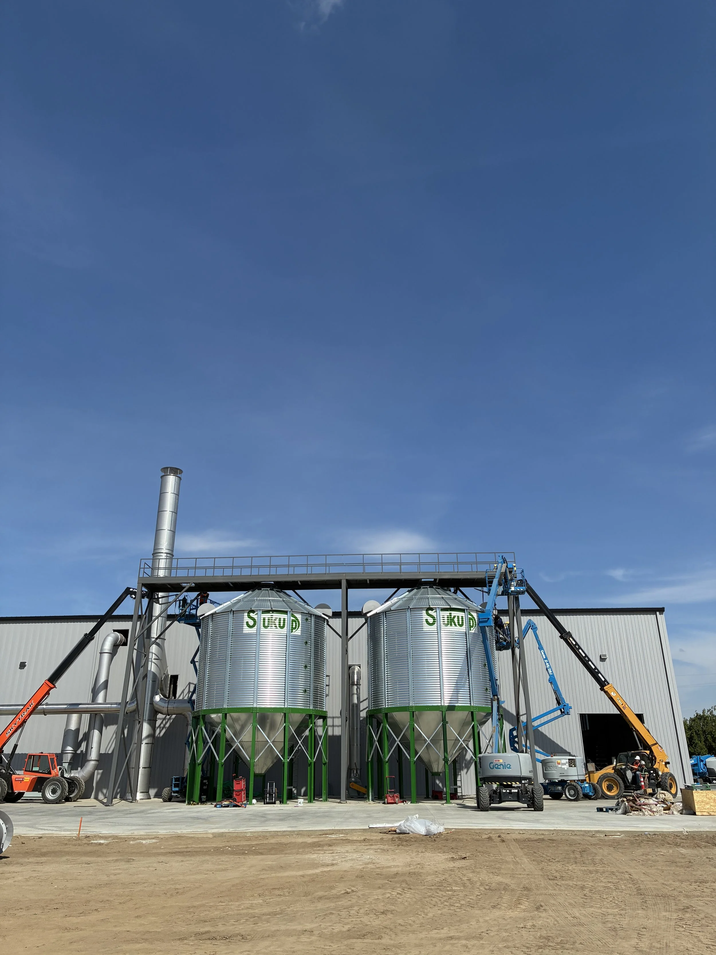 Agricultural biomass feedstock hoppers used in Sitos Group’s commercial biochar production process
