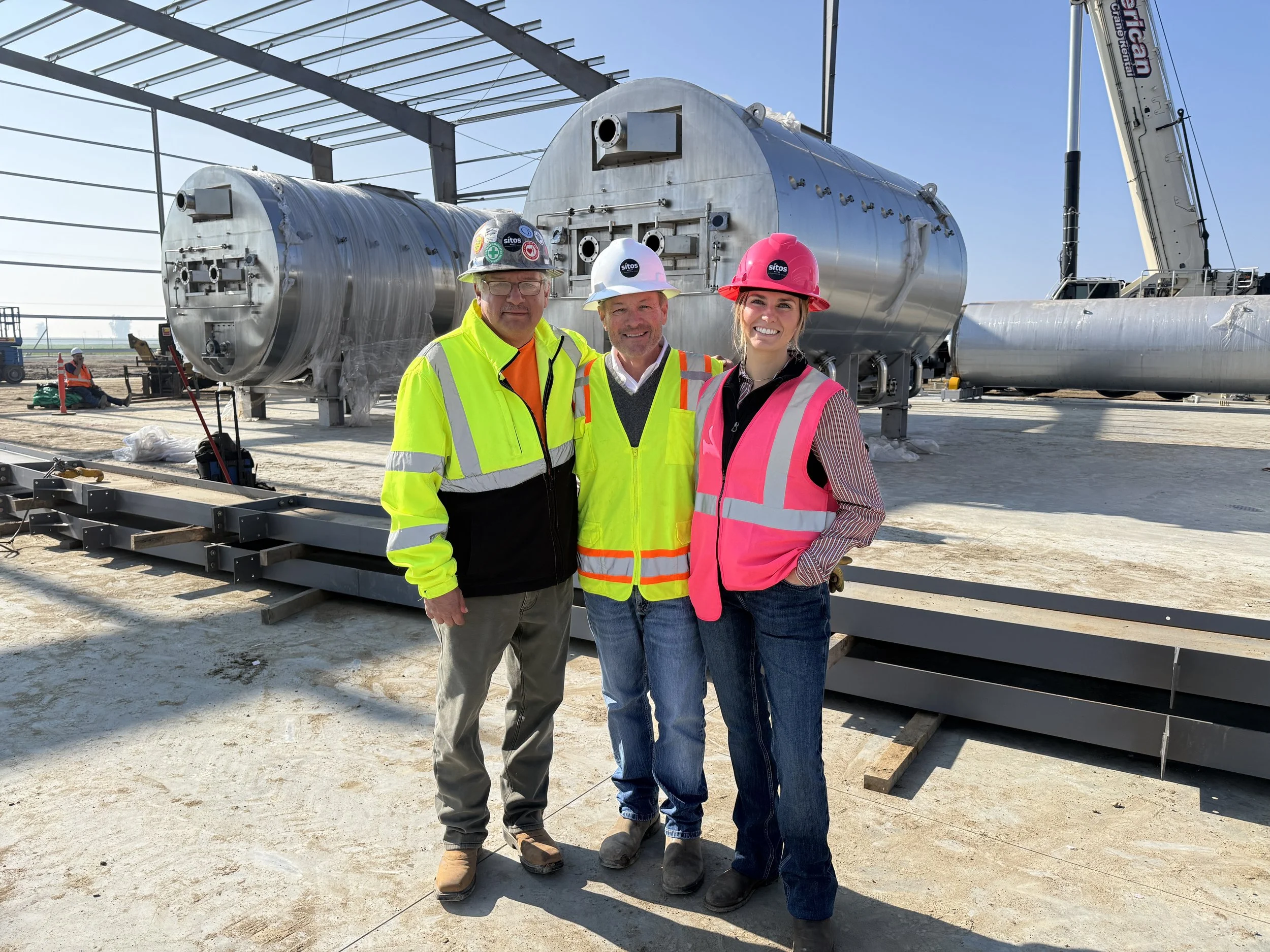 Sitos Group team (Robert C., Mayo Ryan, and Jessica Bronner) in front of biochar reactor.