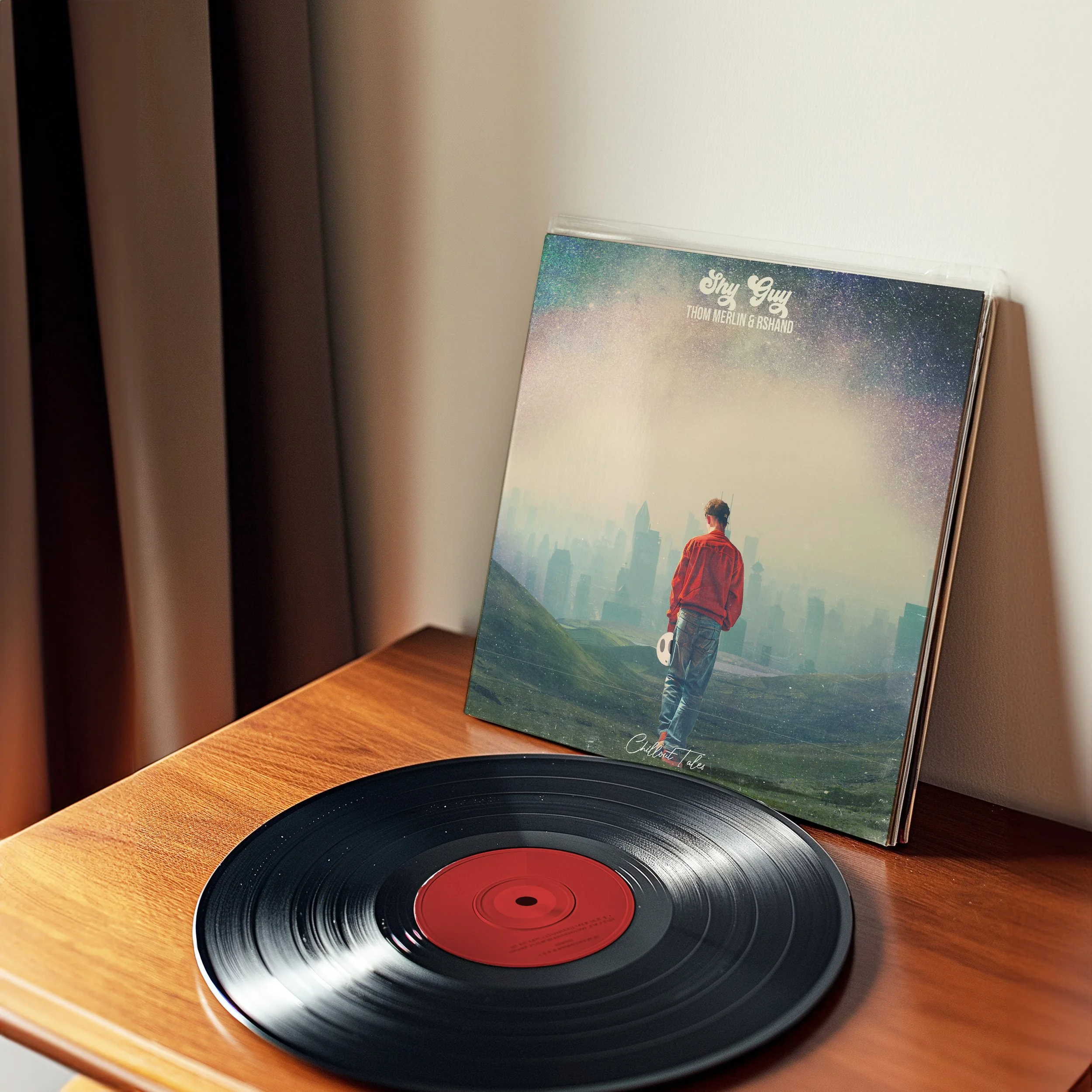 Vinyl record player with a black record on a wooden table, and an album cover for Sky Guy propped against a white wall in the background, with a person facing a cityscape on the album cover.