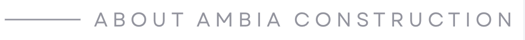Logo with the text 'About AMBIA Construction' in gray font on a white background.