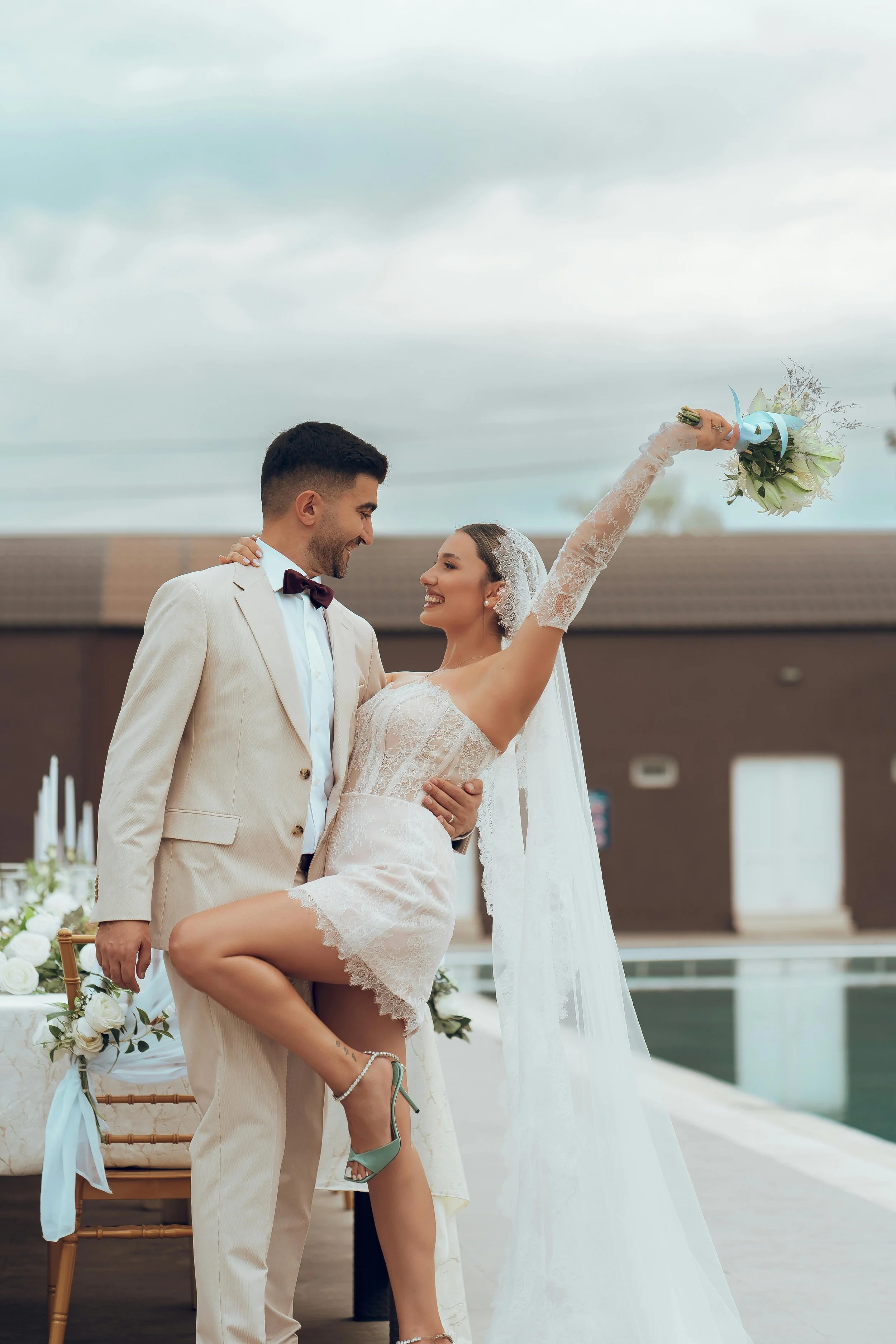 Bride and groom gazing at each other by a pool — wedding planned by Regal Rendezvous luxury event planner Baltimore