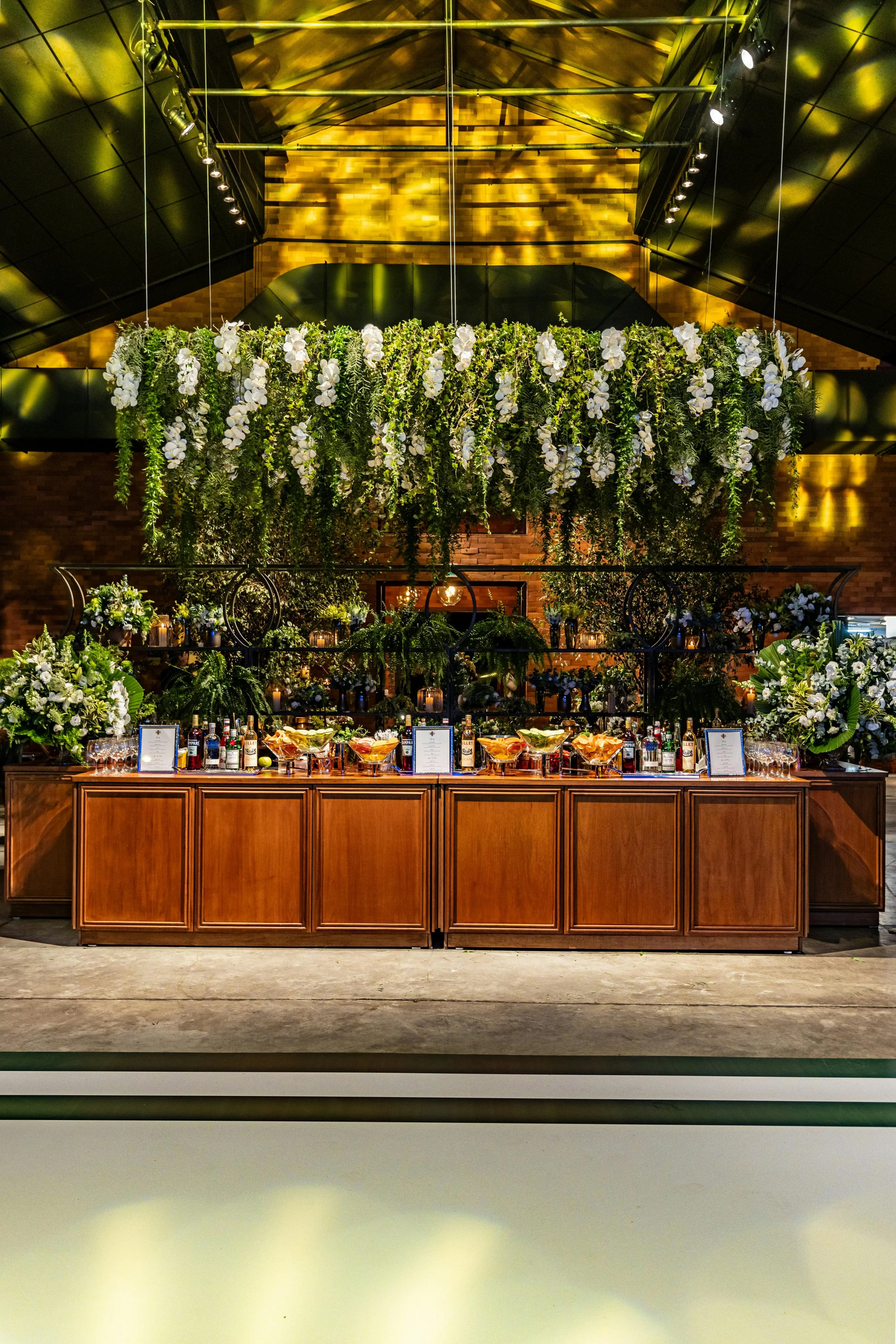 Luxury event venue with floral chandelier above rustic bar styled by Regal Rendezvous wedding and event planner Baltimore