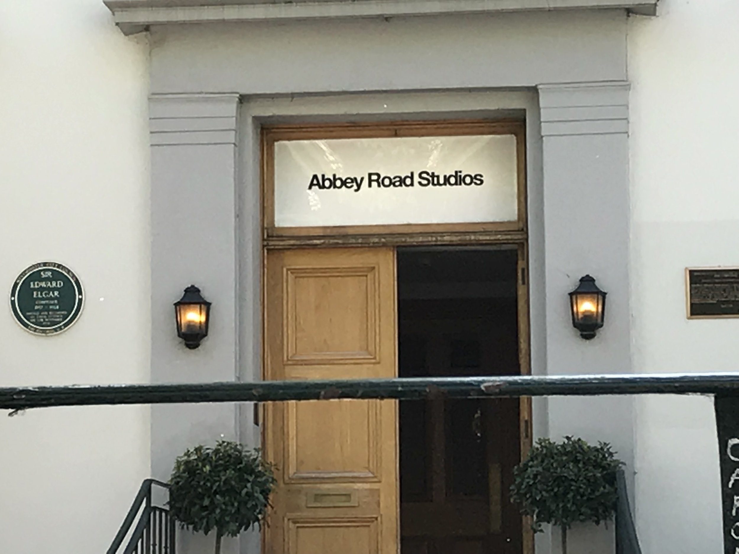 Entrance to Abbey Road Studios with a sign and decorative lighting.