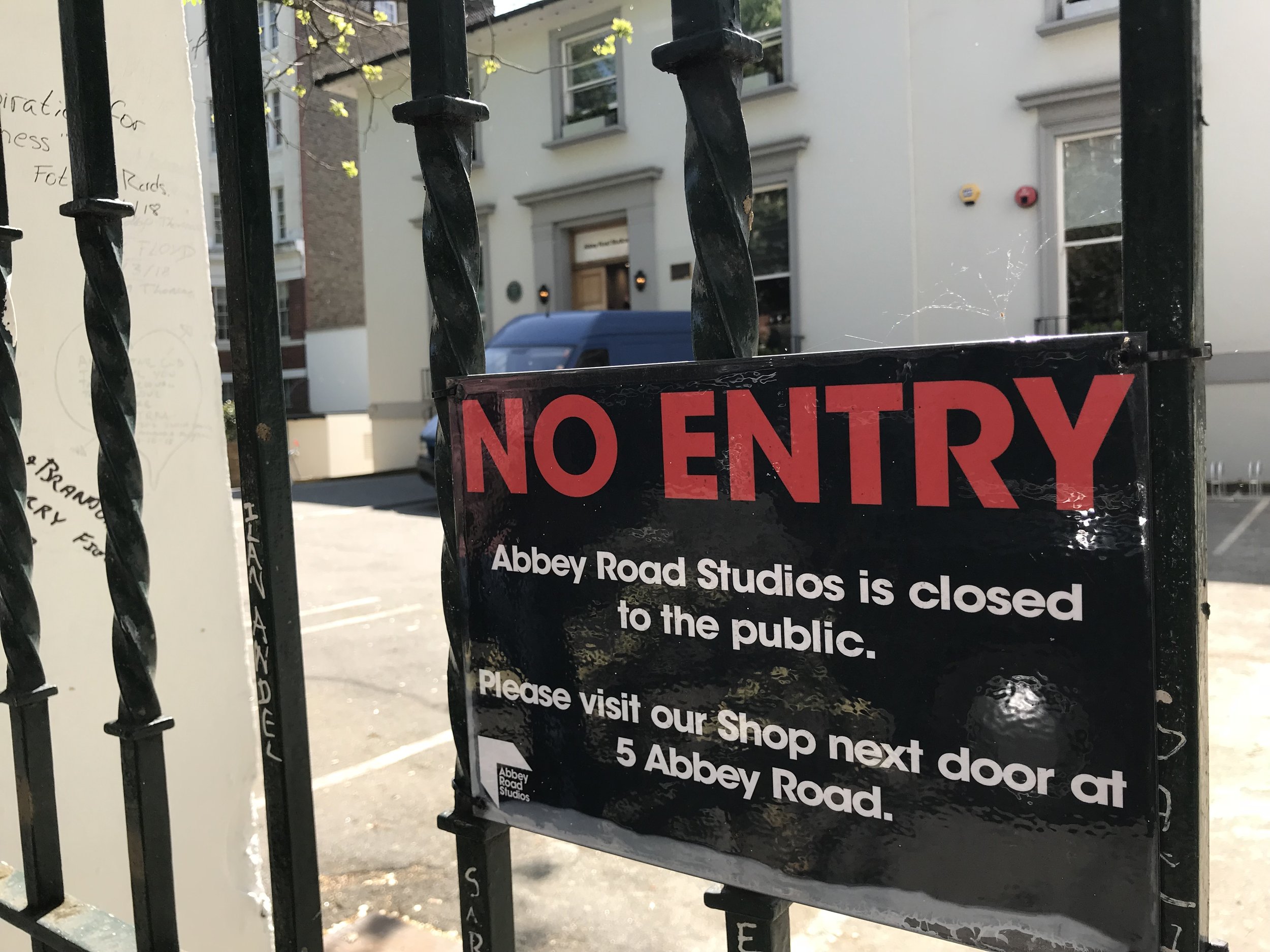 "No Entry" sign at Abbey Road Studios gate, indicating closure to the public and directing to the shop next door.
