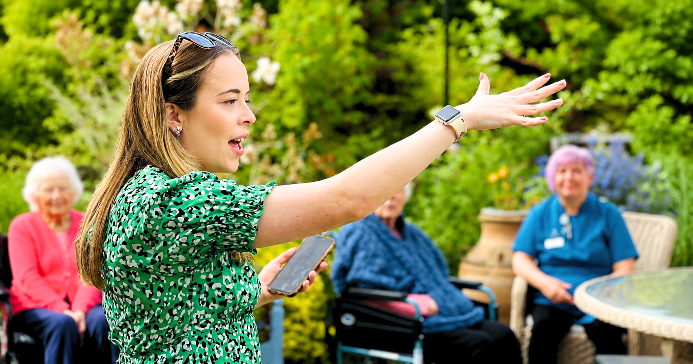 Sophie leading a joyful outdoor Care Home Choir session for dementia and Alzheimer's residents in Bristol with Stand Out Performing Arts