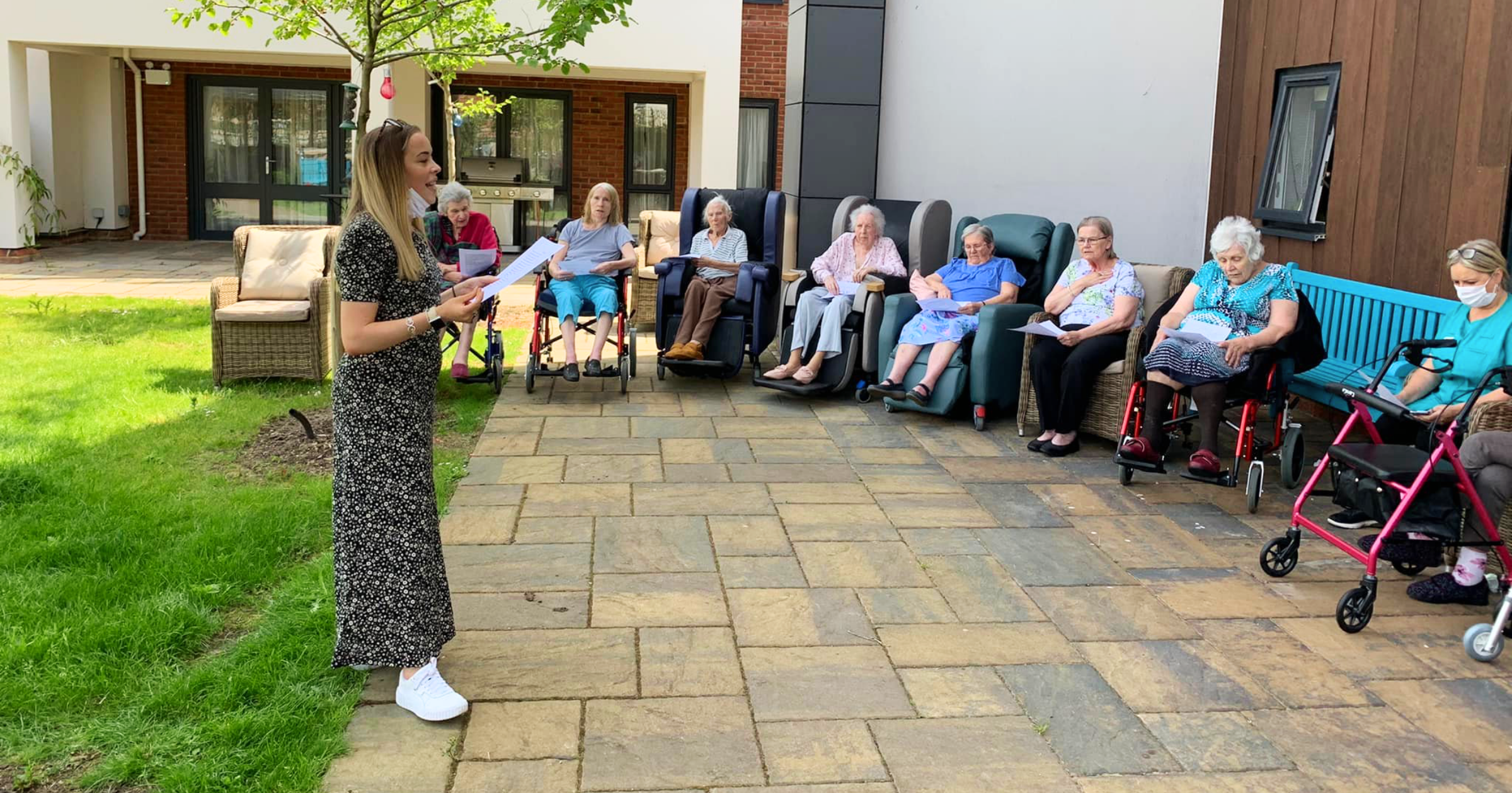 Stand Out Performing Arts Care Home Choir session with Sophie performing for a group of elderly residents in a care home garden in Bristol