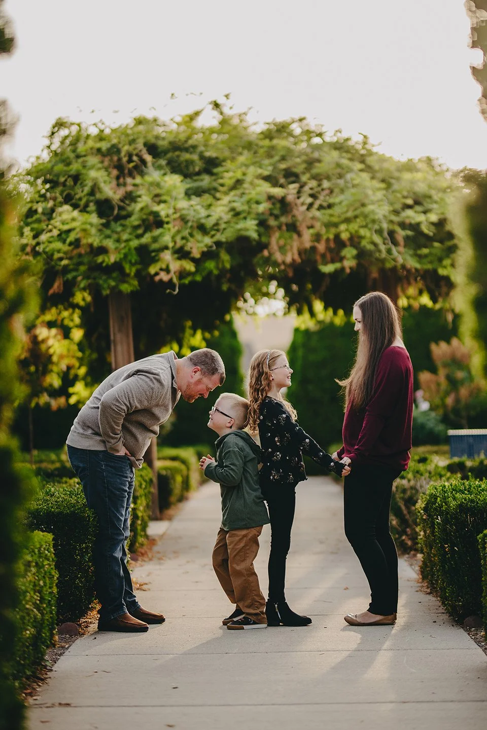 Vineyard family photos in the Tri-Cities with a family of four — warm golden-hour light, soft movement, and natural, joyful moments among the vines in Kennewick, WA