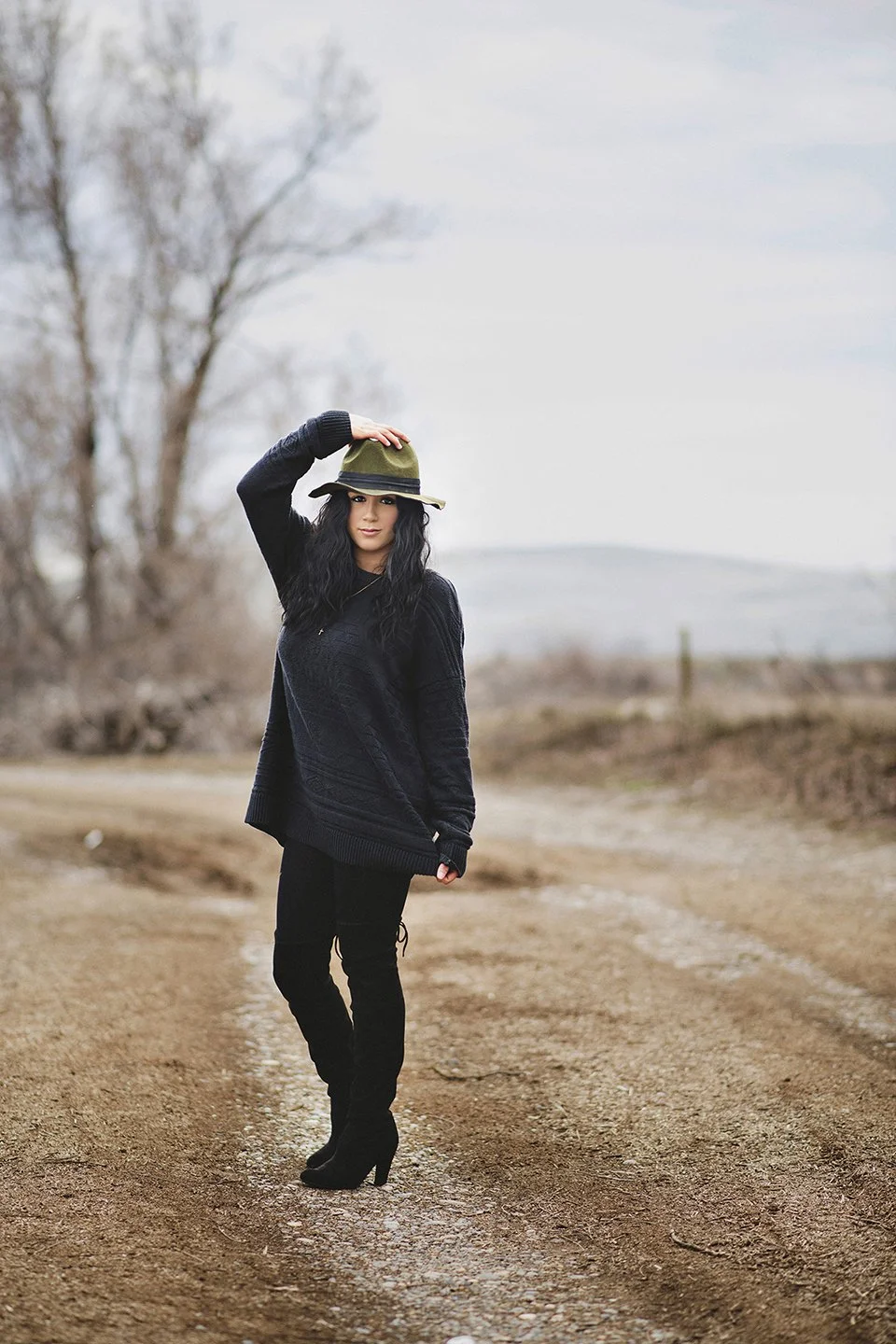 Bold editorial portrait with Cora centered on an empty country road at golden hour in Granger, WA
