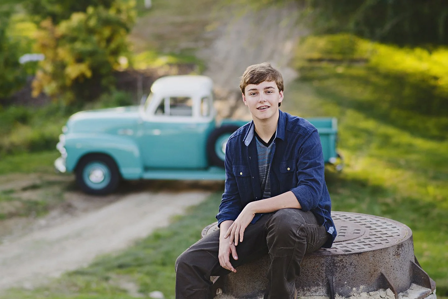  A classic summer senior portrait featuring a vintage Chevy and warm green tones, Kennewick, WA