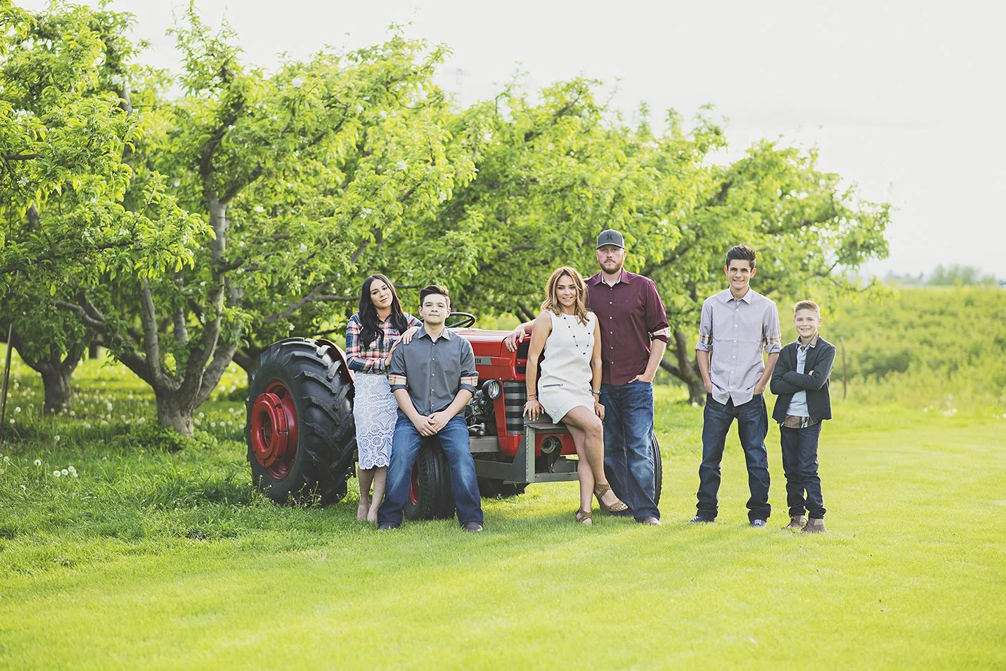 Family of four in Zillah, WA with tractor and cherry orchard during spring.
Description: A stylish spring family session in Zillah surrounded by cherry blossoms and their tractor, with soft Burberry tones.