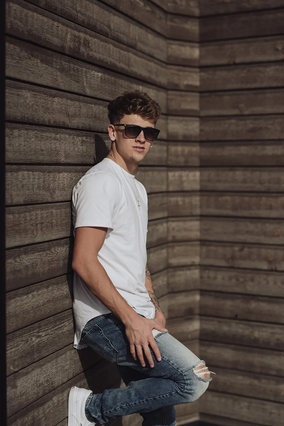 A clean, modern close-up with sharp light, glasses, and timeless Prosser style.