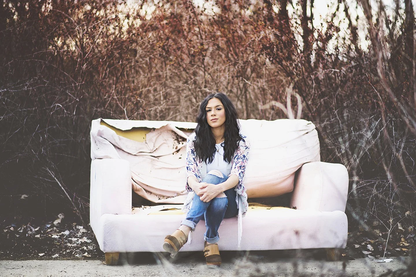 Playful country-style senior portrait with a vintage pink couch in Zillah,WA