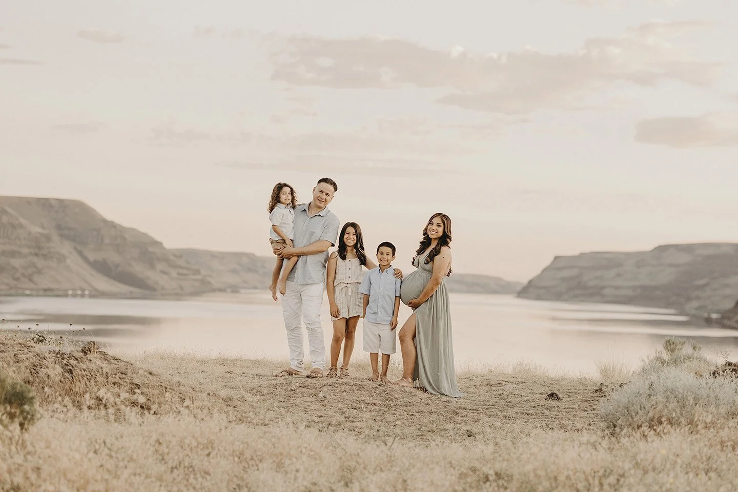 A beautiful and heartfelt family maternity portrait at Twin Sisters Rocks, where soft pastel tones and the Columbia River backdrop frame a serene moment for this soon-to-be family of five.