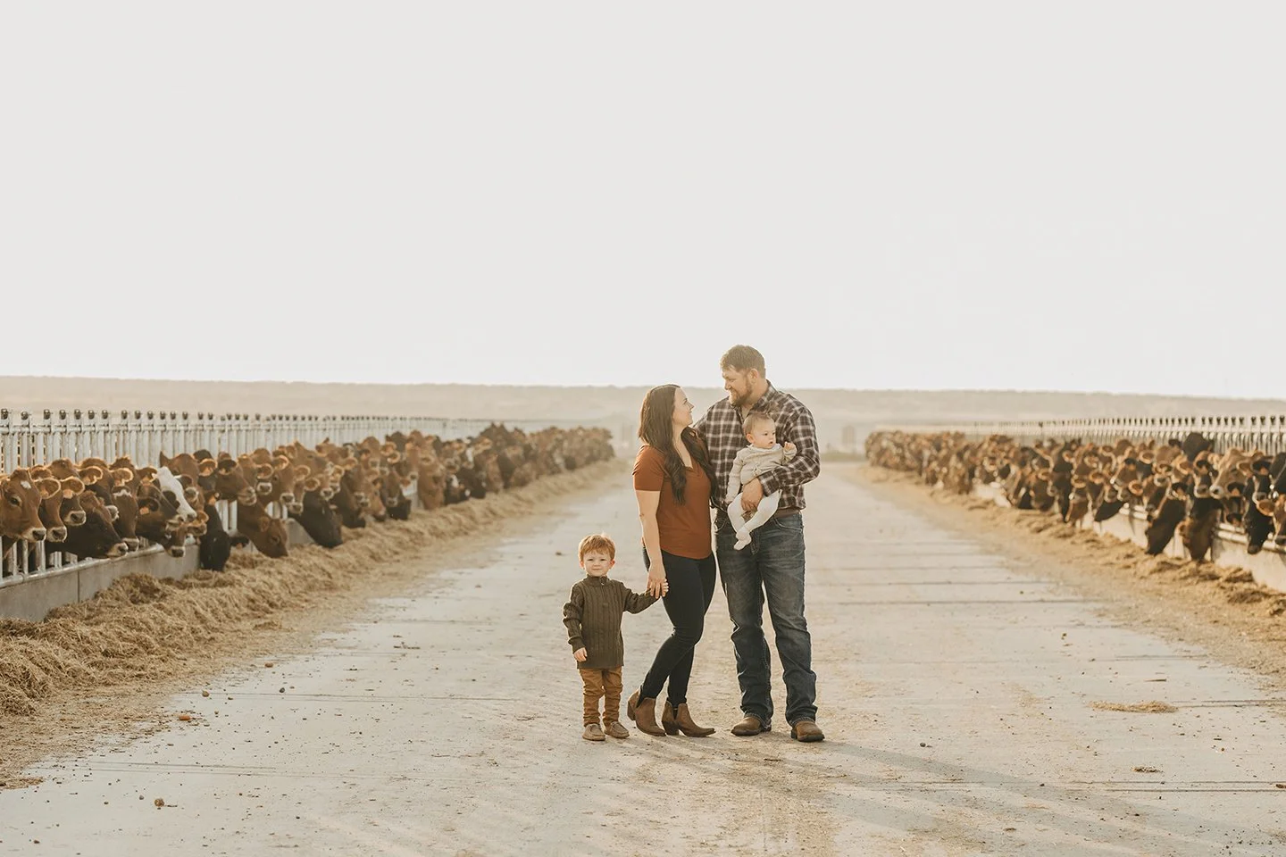 A warm and authentic family moment at their Mabton dairy during golden hour.