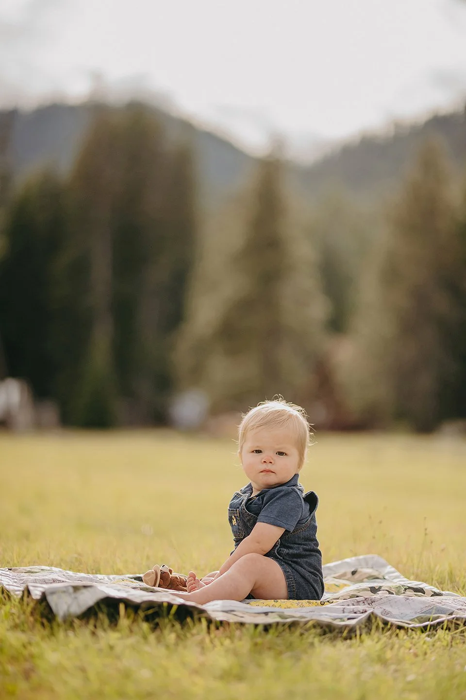 Portrait of a little boy in Naches, WA with a soft forest background — natural light and a calm, outdoorsy feel.