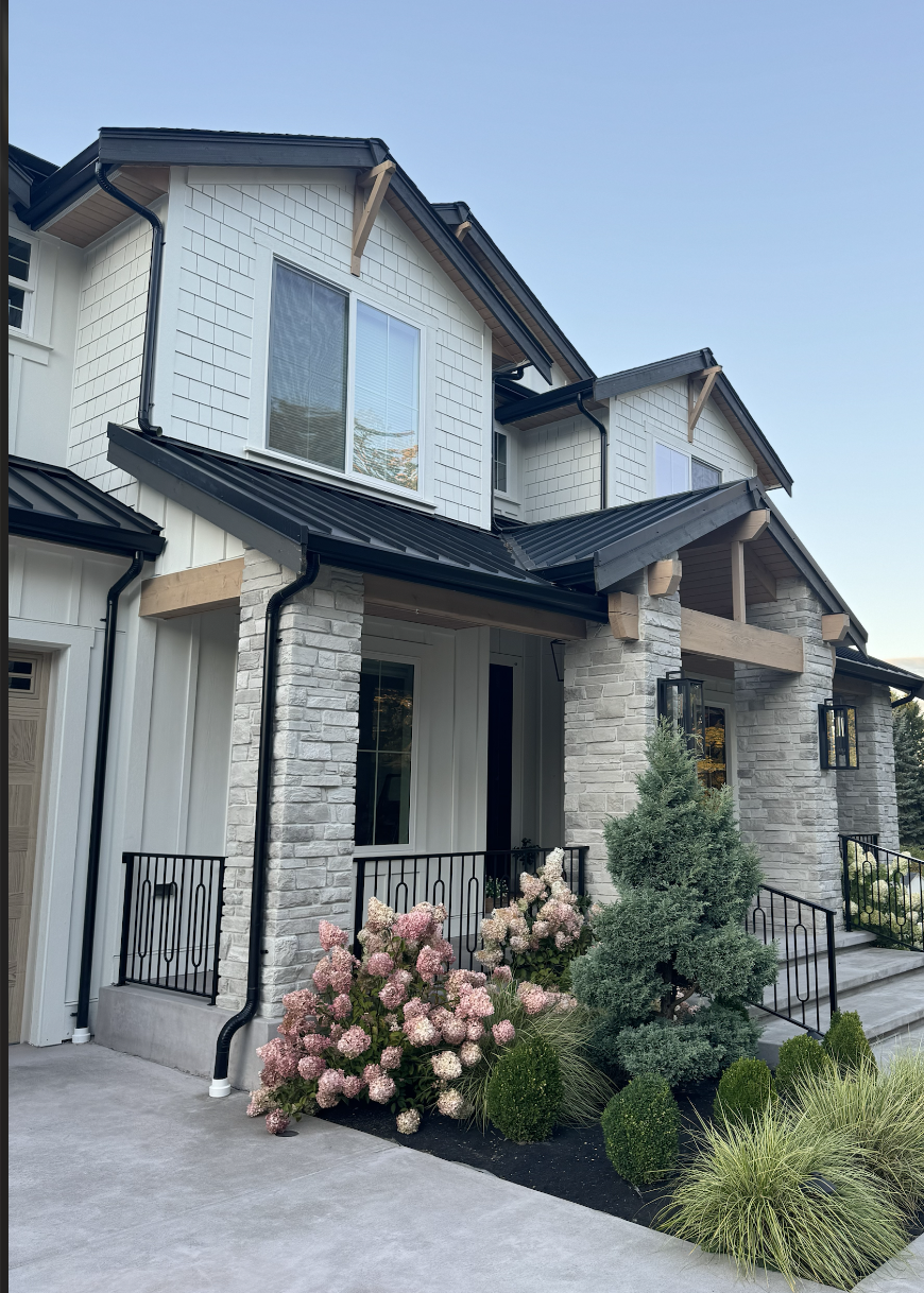 Custom metal staircase with integrated entry canopy fabricated and powder coated in-house