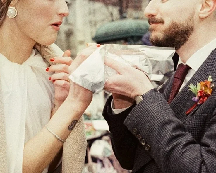 Newlyweds share a hot dog outside new york city hall on film