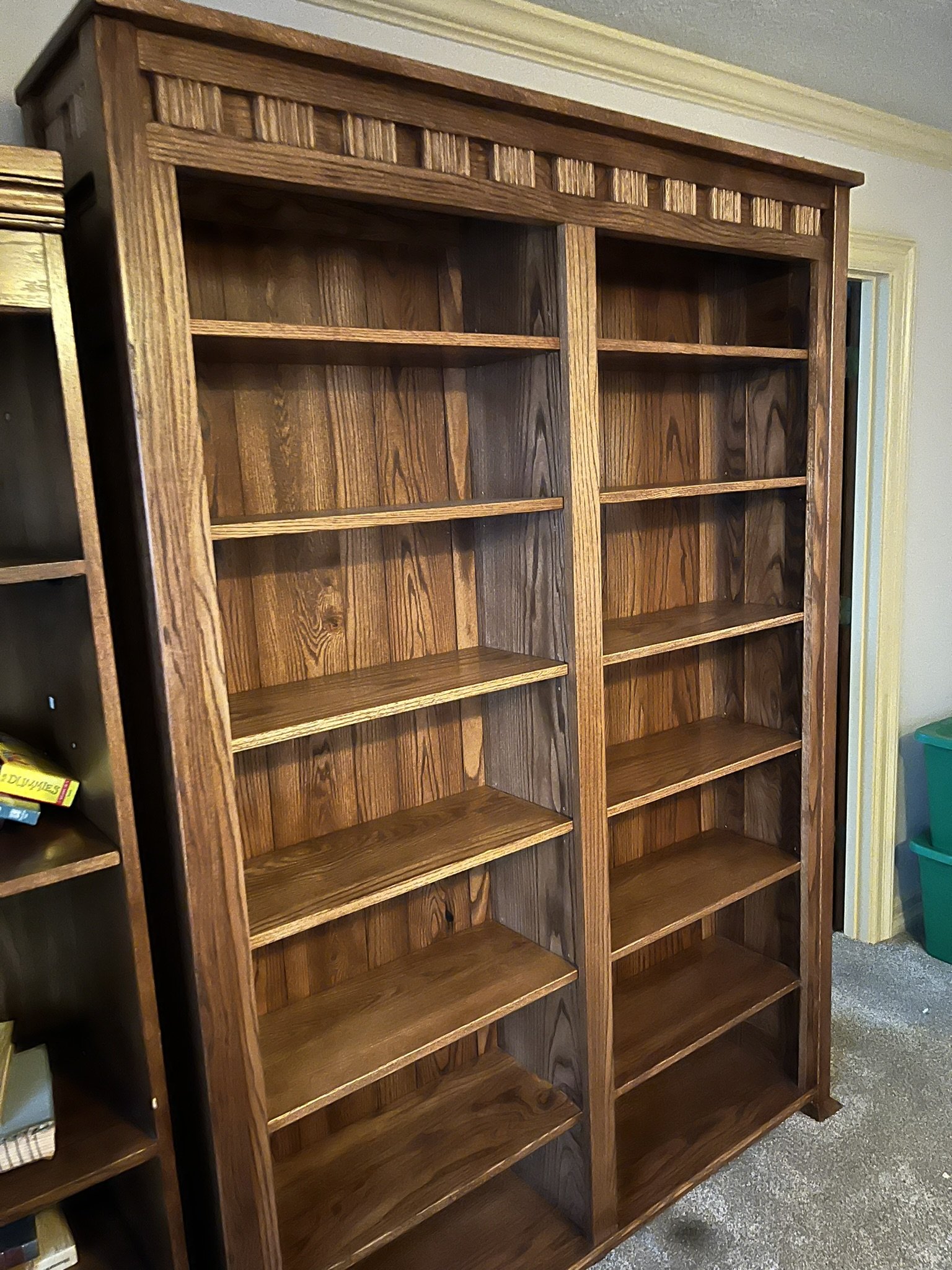Empty wooden bookshelf with multiple shelves and brown finish.