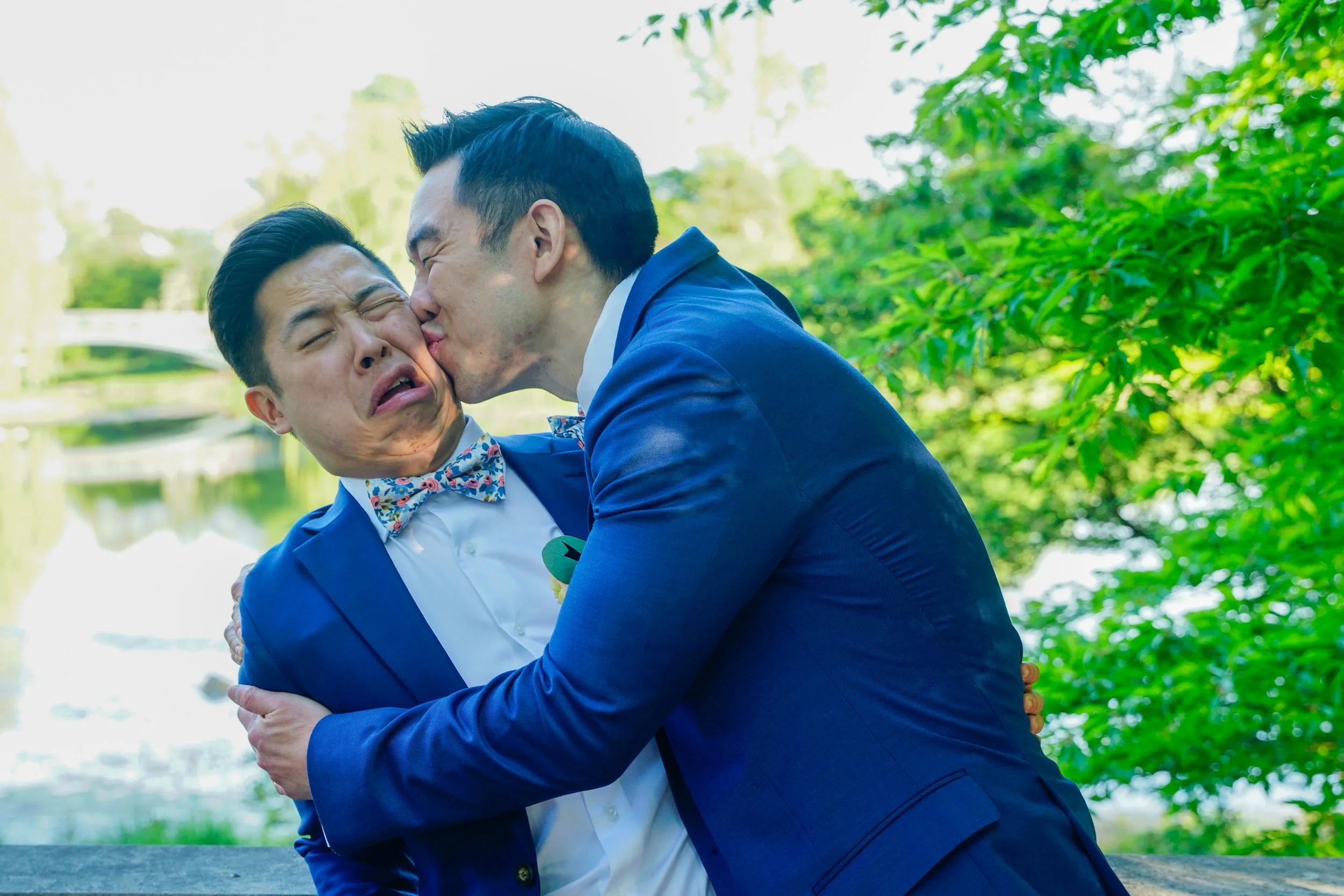 groomsmen kissind groom on cheek.jpg