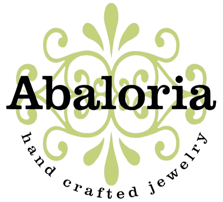 Stylized decorative logo with the word 'Abacora' in black text and a flourish design around it, with additional text 'The craft jewelry' surrounding the logo.