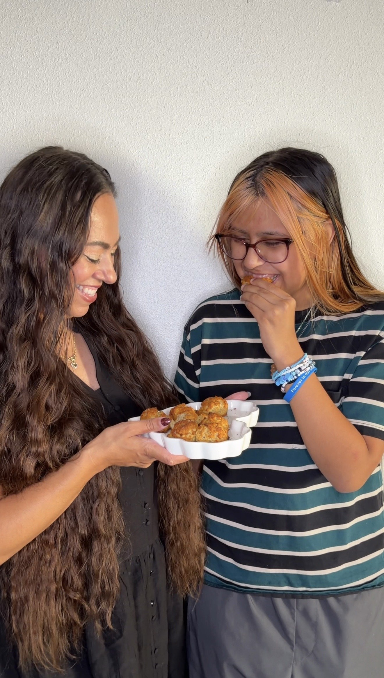 Mom and daughter taste-testing homemade TruEats gluten-free biscuits