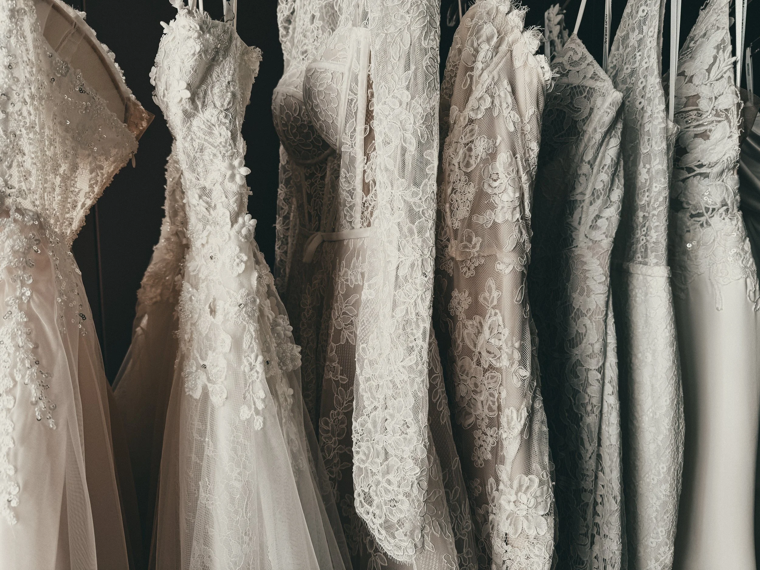 Detail of ivory lace floral appliqué and tulle overlay on a romantic wedding gown at Art & Lace Bridal in Massachusetts.