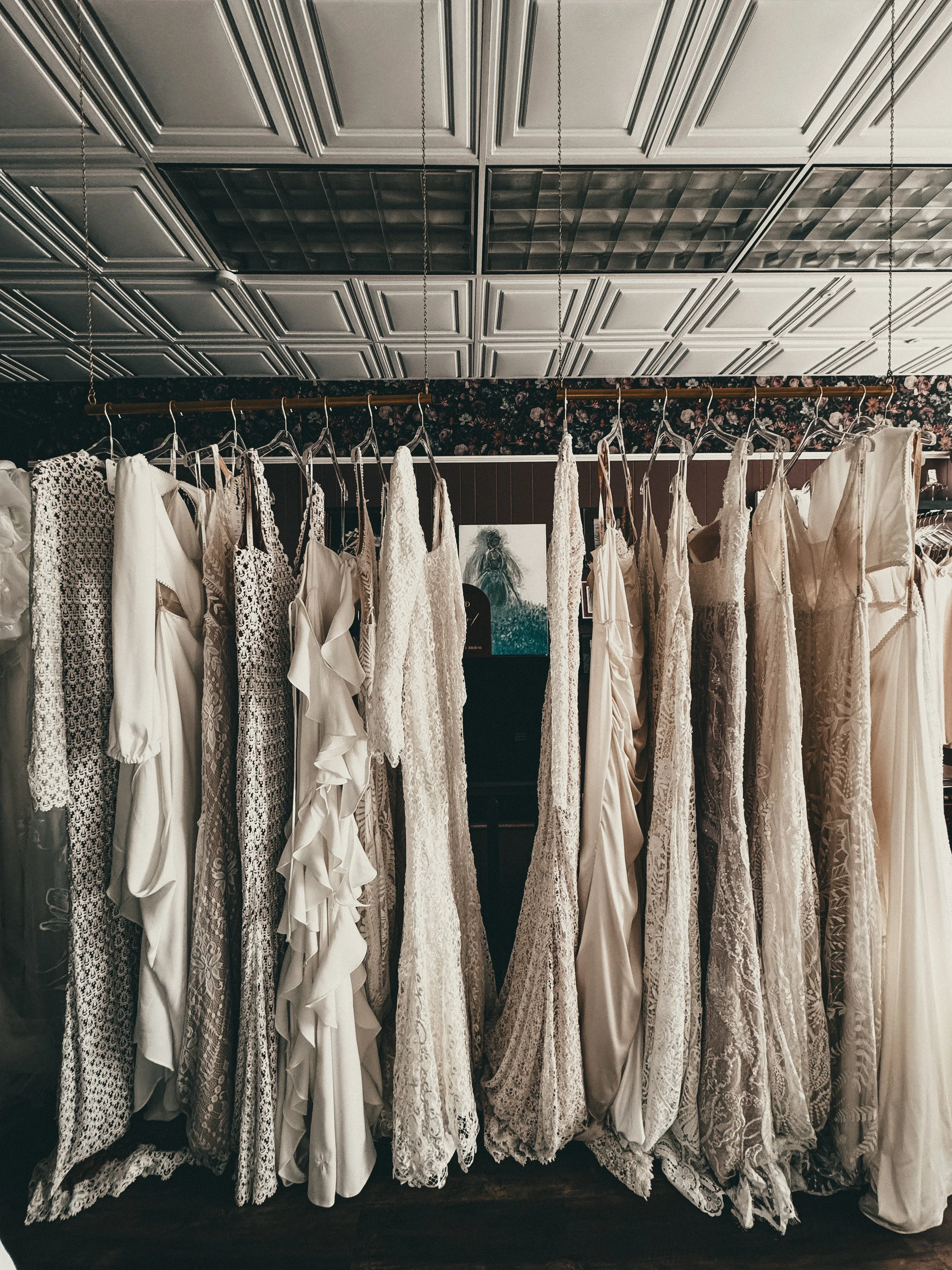 Vintage-inspired bohemian gowns in mixed lace and satin fabrics at Art & Lace Bridal in Somerset, MA.