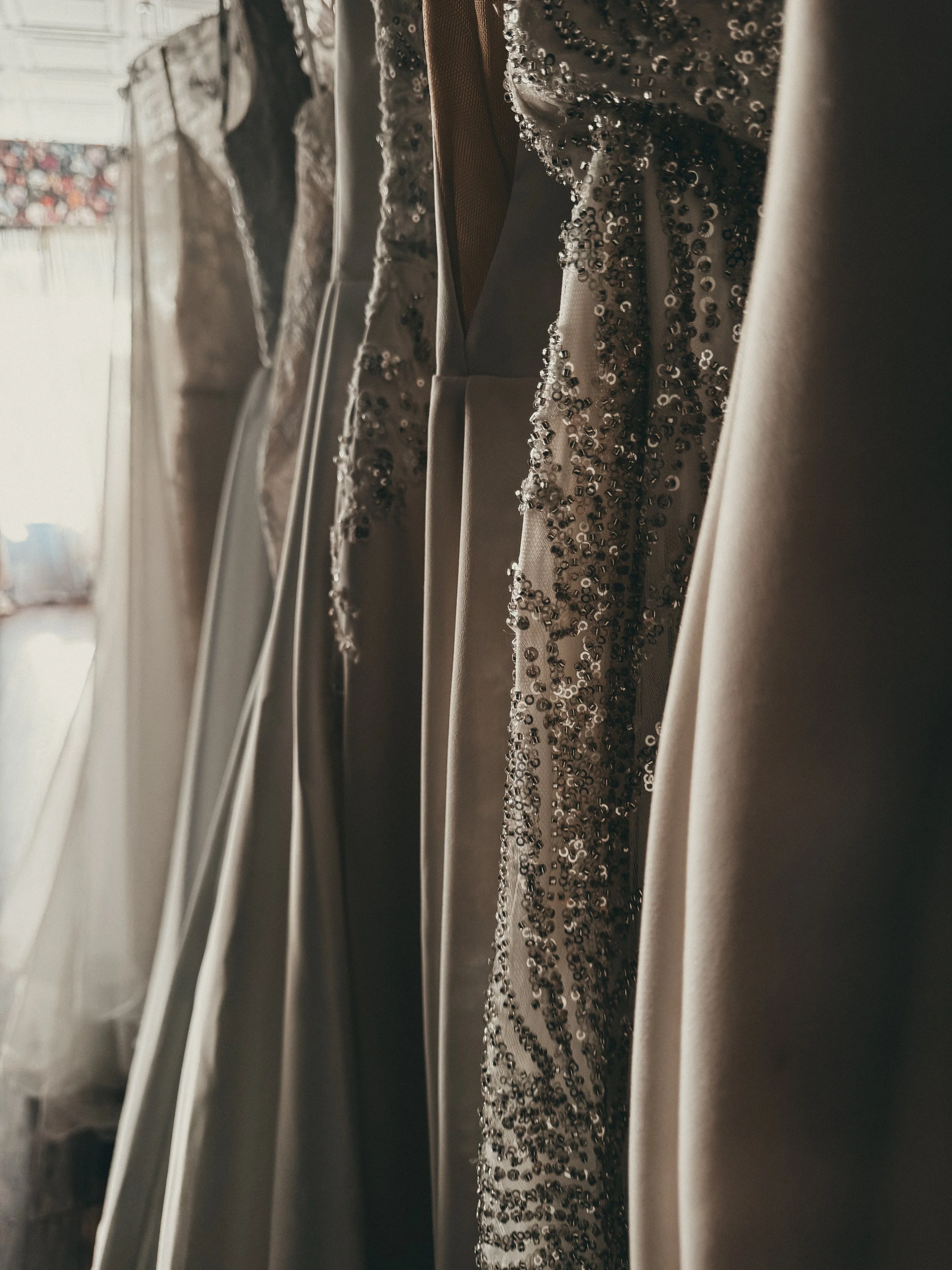 Close-up of hand-beaded sequin trim on a refined classic wedding gown at Art & Lace Bridal, MA.