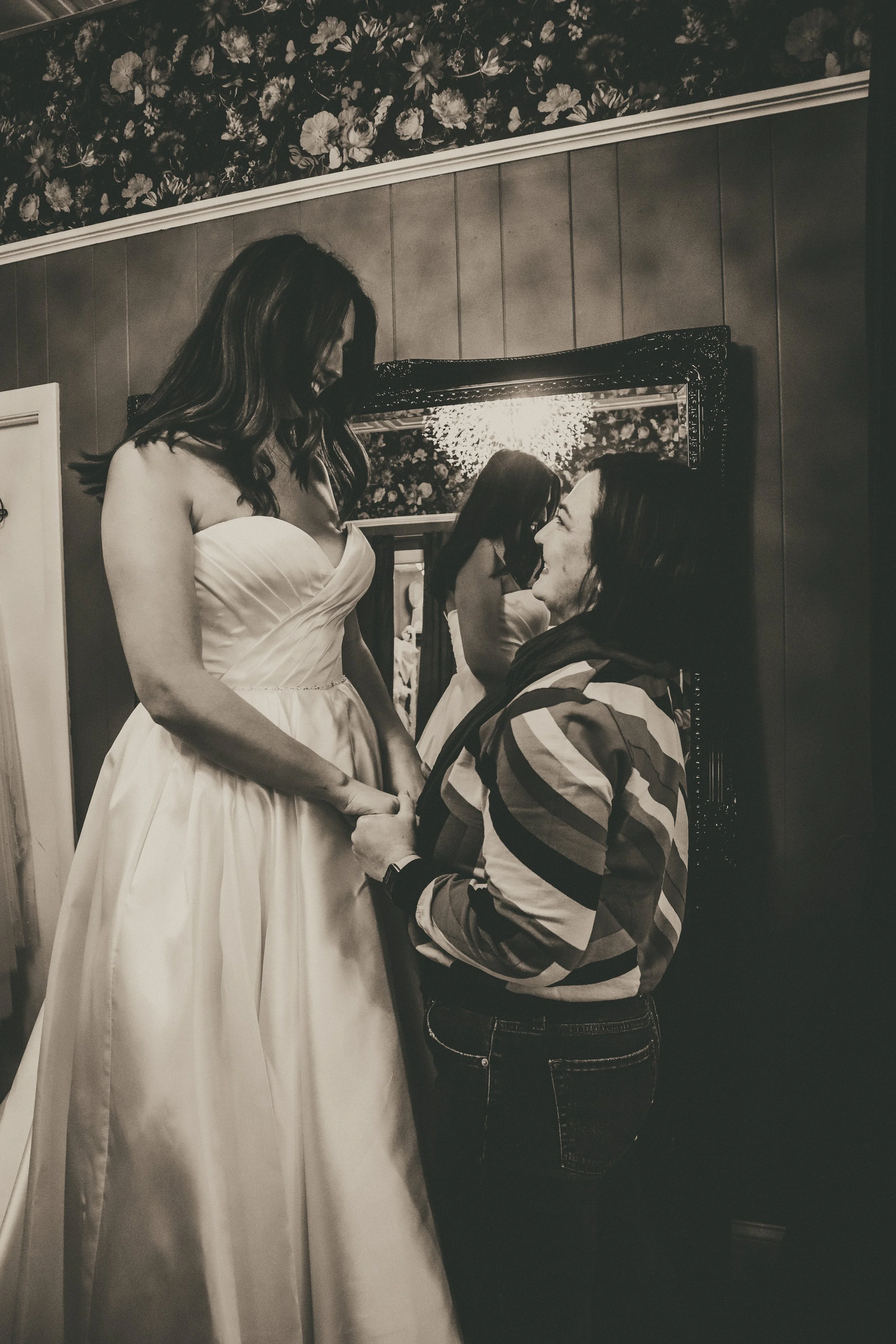 Samantha Almeida helping a bride into her wedding gown at Art & Lace Bridal — a private, unhurried styling experience in Somerset, MA.
