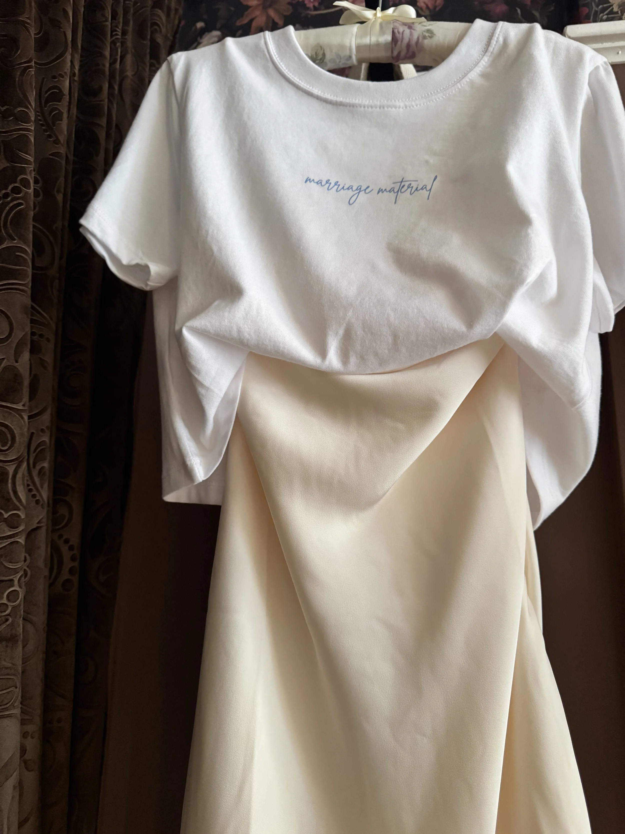 The Marriage Material Tee styled over a champagne satin skirt for a modern bridal look