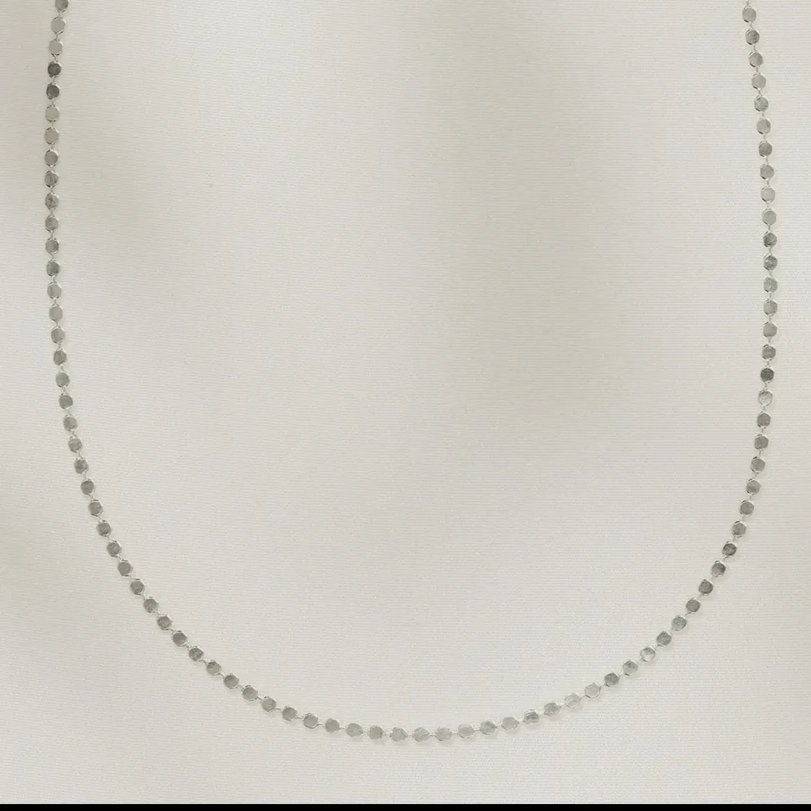 Anatole Silver Choker — a delicate silver bead-strand choker laid flat on ivory paper