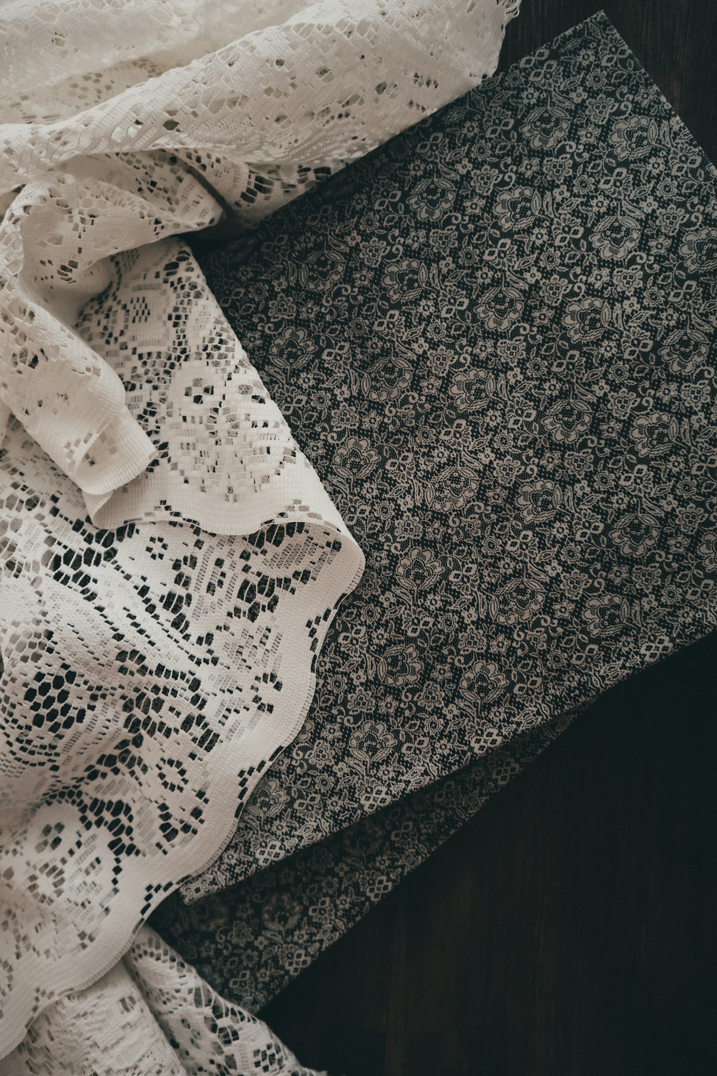 The Lace Journal — a 154-page luxury bridal planning workbook with a dark floral hardcover, styled on a wooden ledge with a blush pillow.